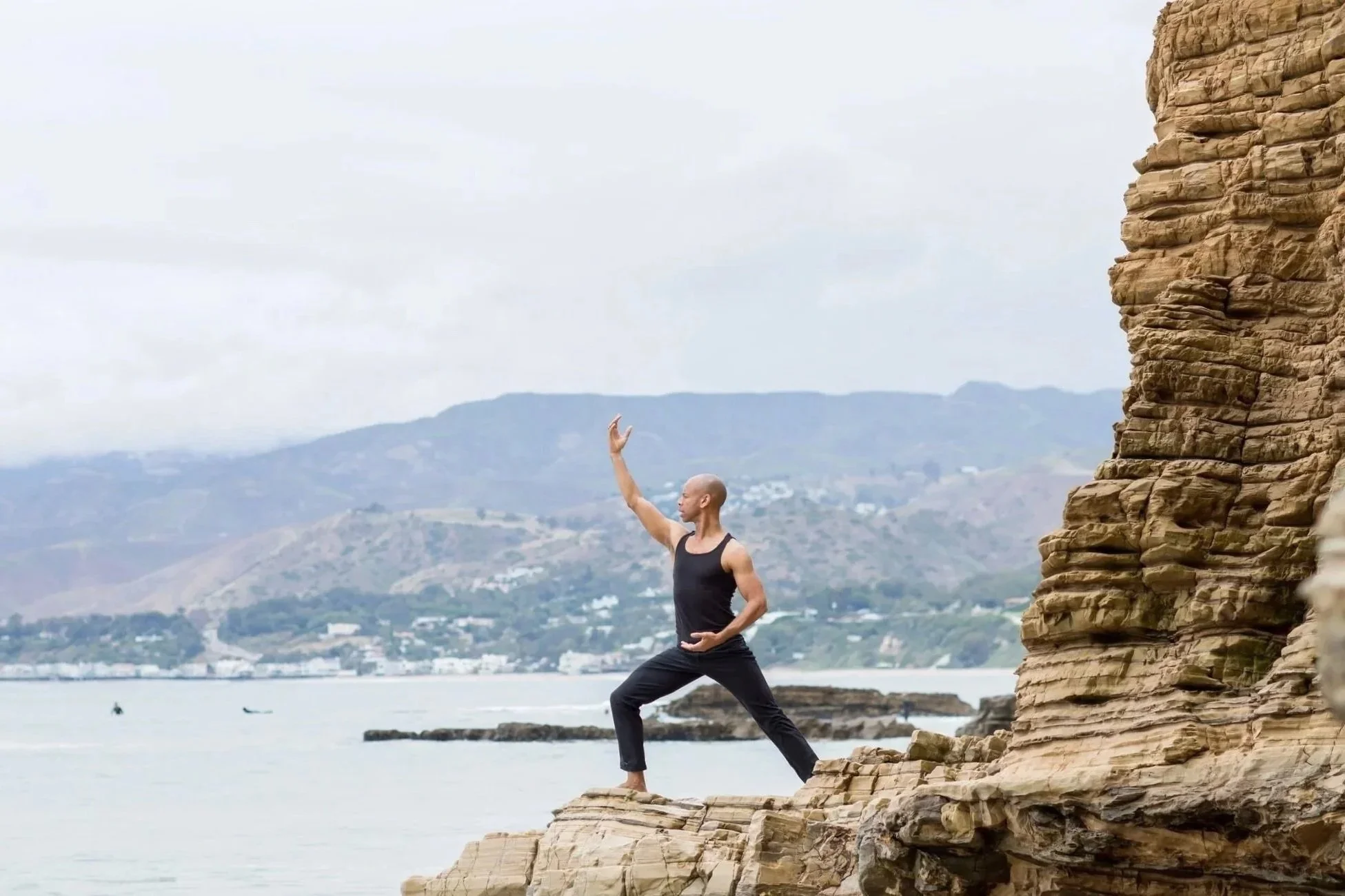 Steven Washington practicing Qigong on a coastal cliff overlooking the ocean