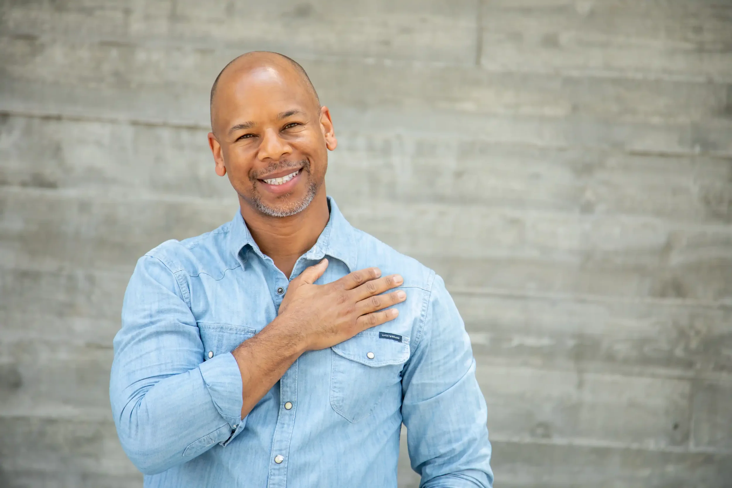 Steven Washington smiling with his hand over his heart, representing SWE Studio.