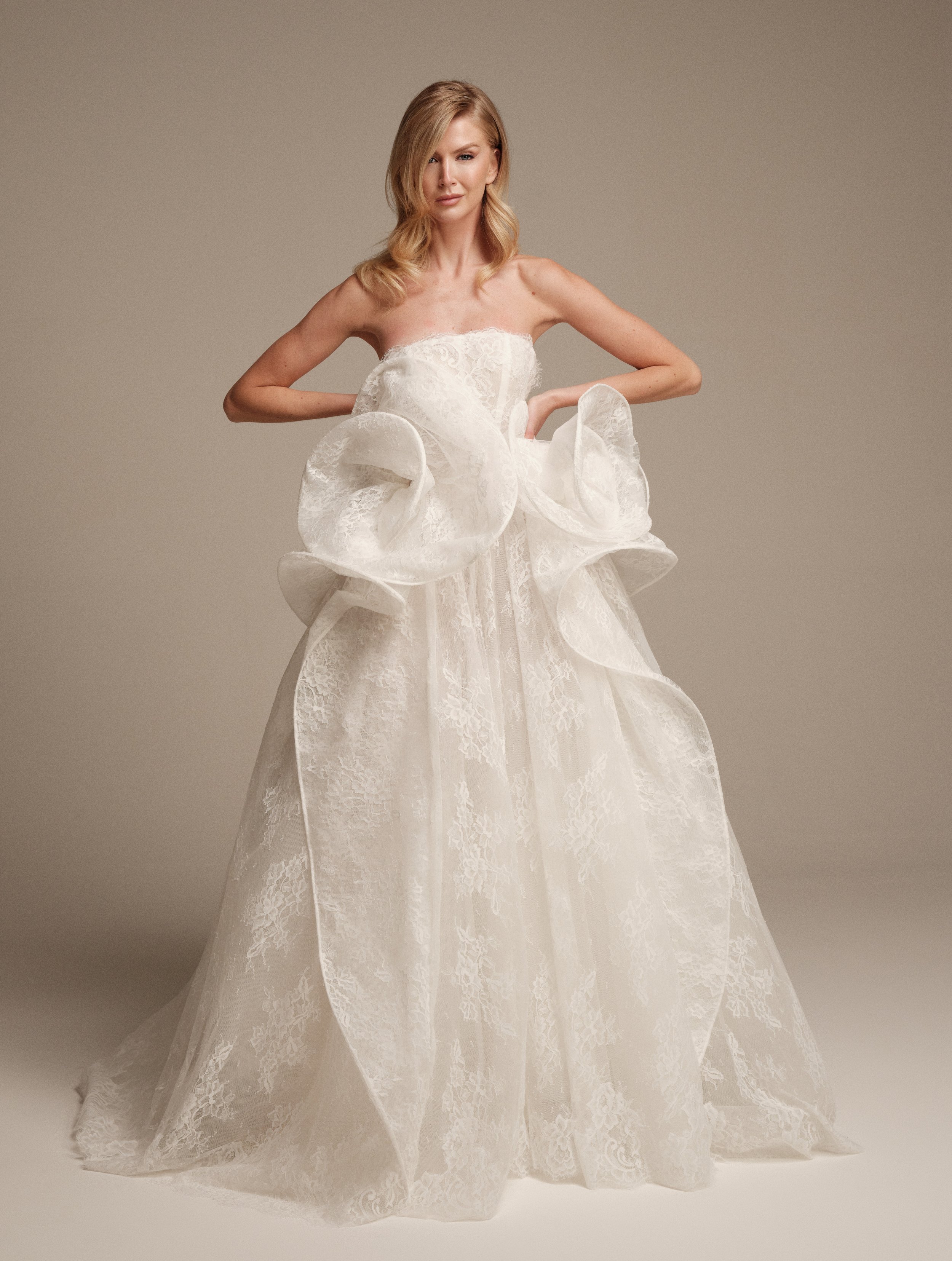 Maria Pia Ceres Chantilly lace wedding dress with sculptural peplum
