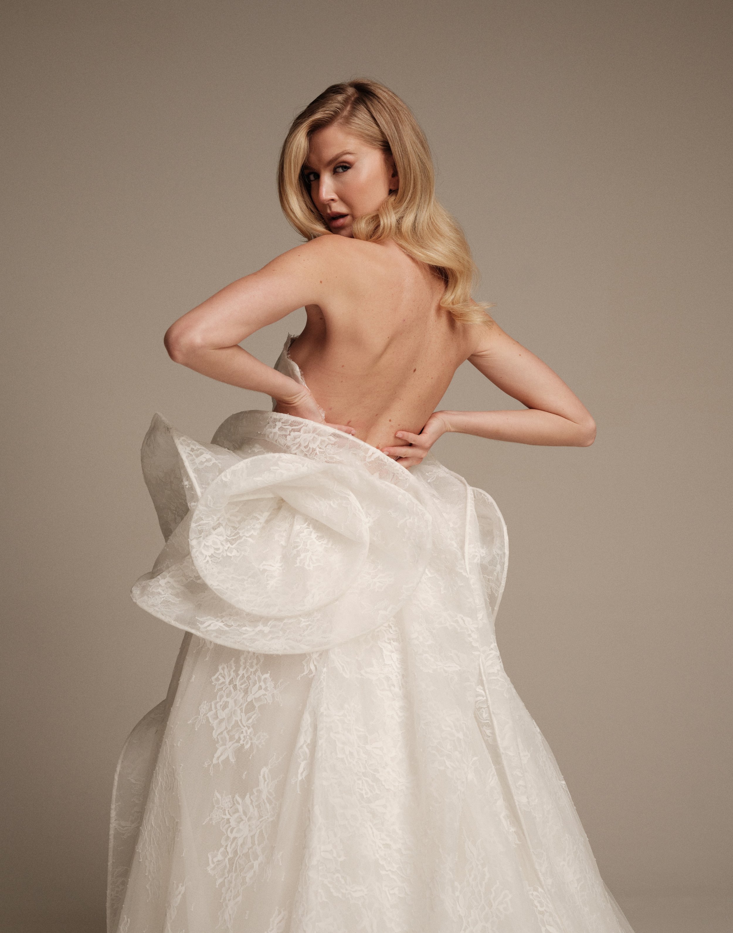 Maria Pia Ceres wedding dress with open back and sculptural lace peplum