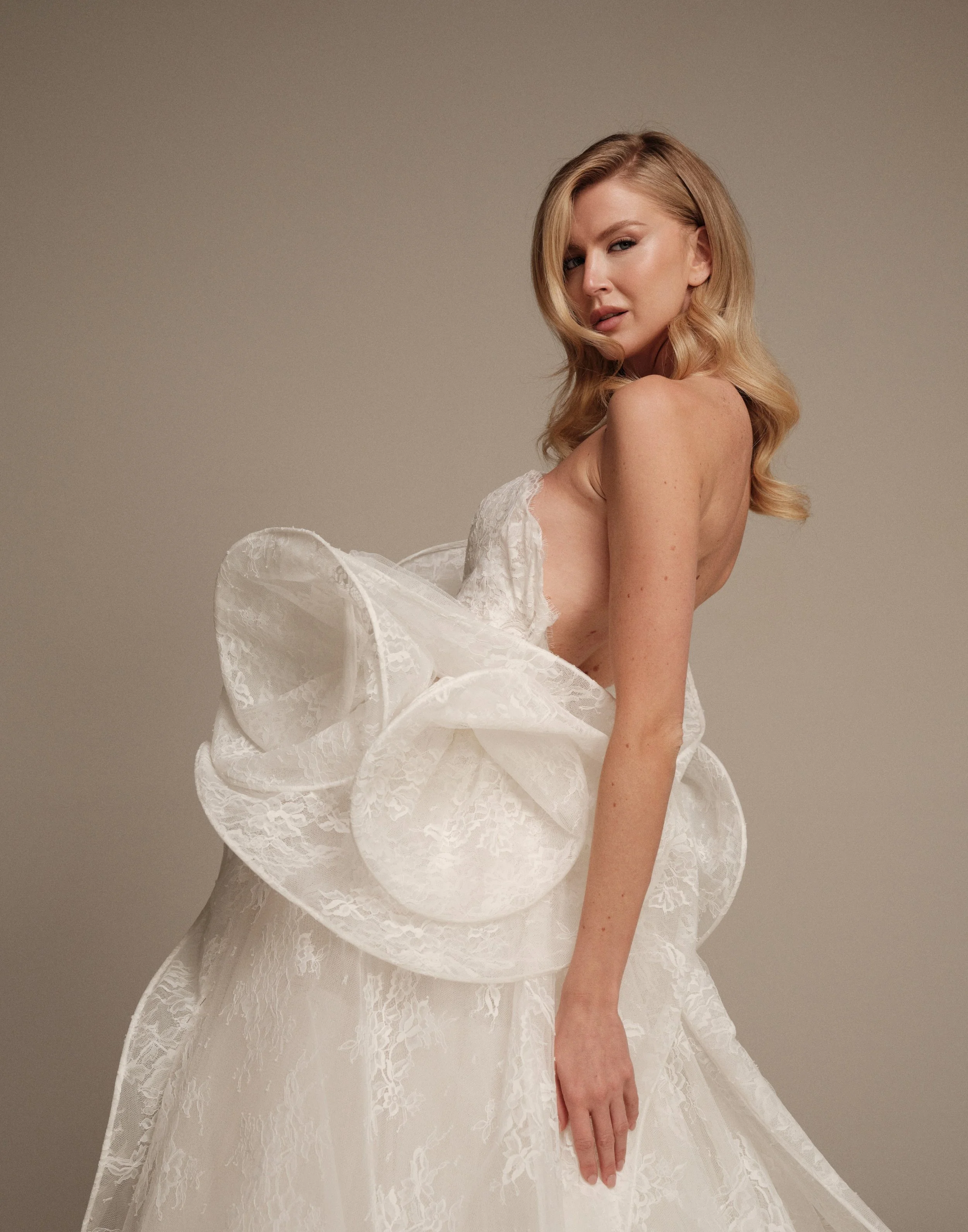 Ceres Italian lace wedding dress with dramatic peplum waist detail