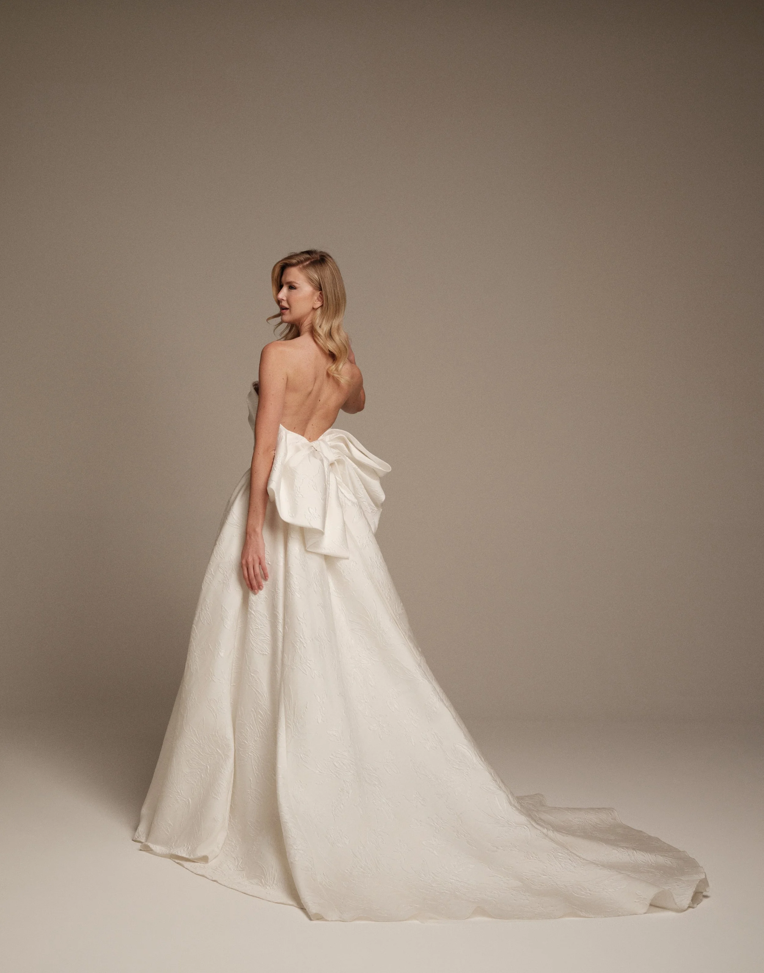 Maria Pia Arianna wedding dress with oversized sculptural back bow and brocade train
