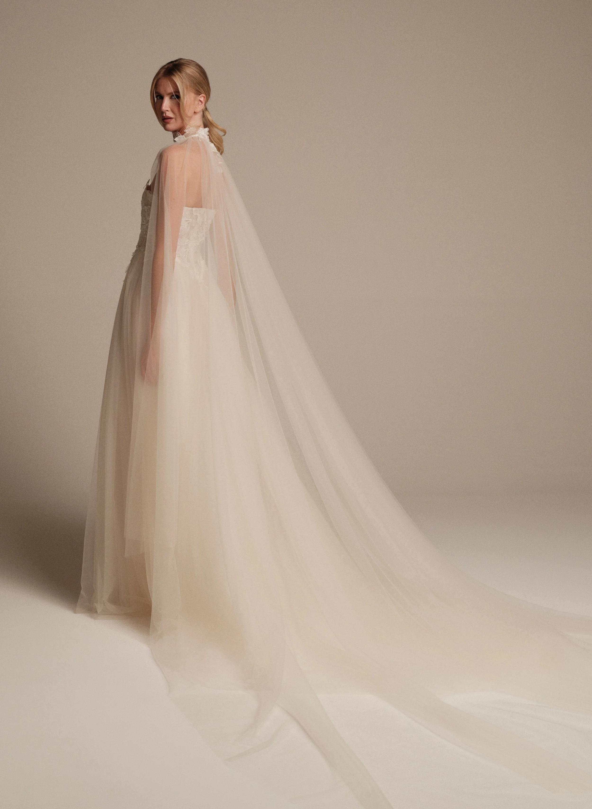 Maria Pia Luna wedding cape in sheer tulle styled over an embroidered bridal gown