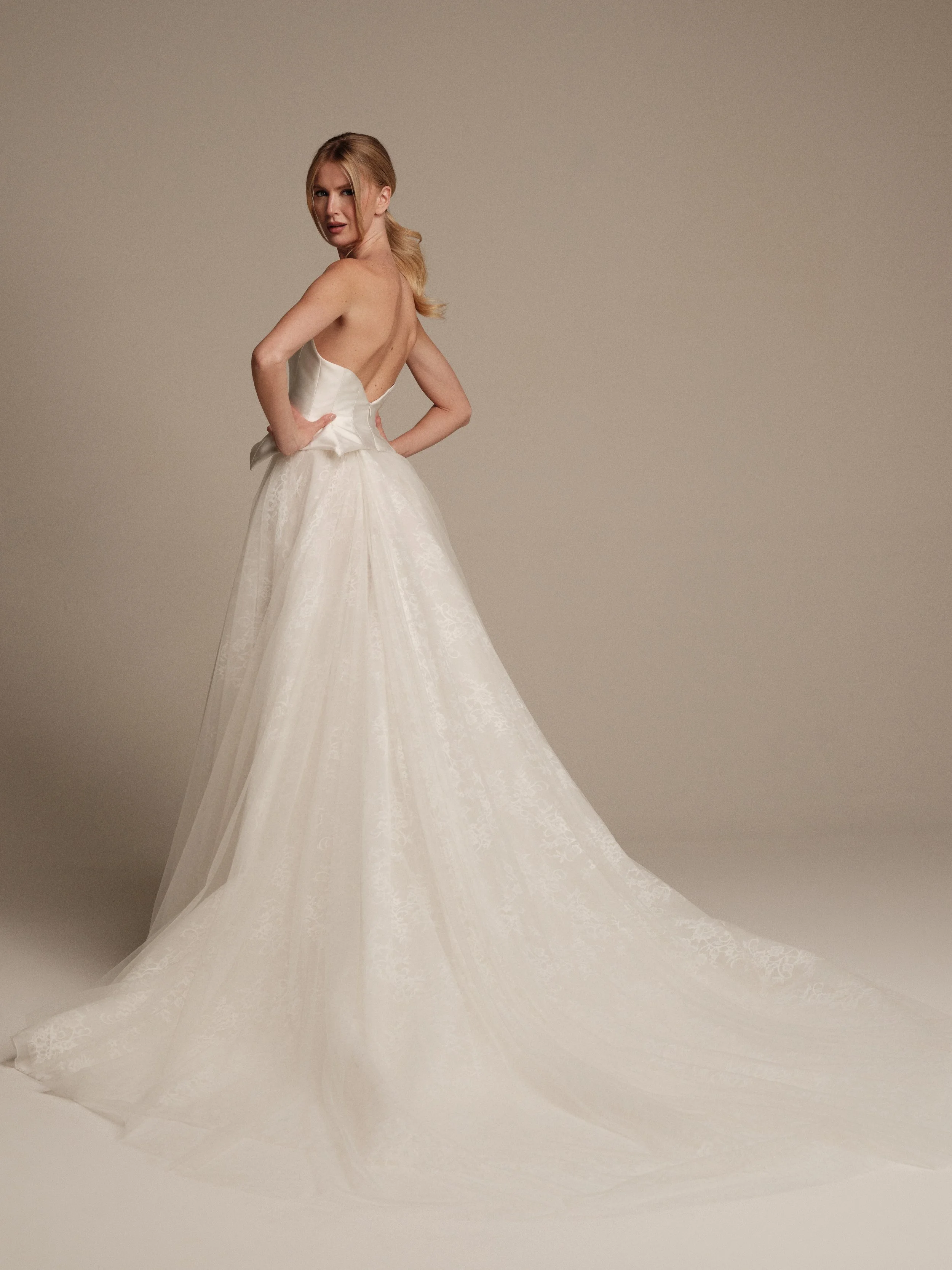 Back view of Gaia two-piece bridal gown with sculpted mikado bodice and flowing lace and tulle train