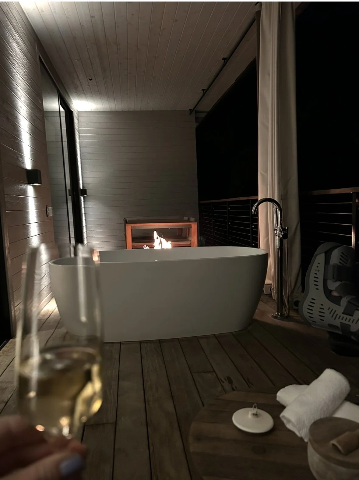 Hot tub and fireplace on balcony of suite at Alila Napa Valley luxury resort in St Helena California