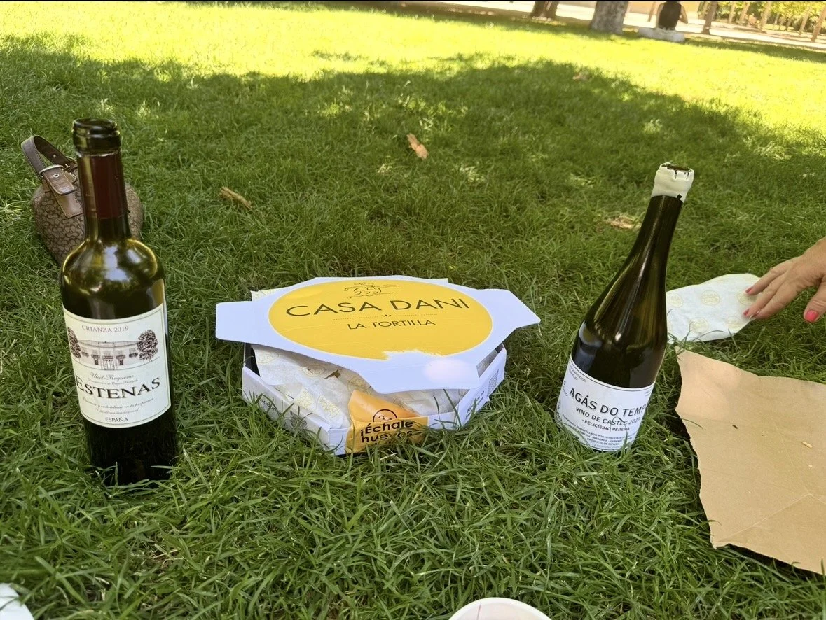 Casa Dani tortilla and Spanish wine during a picnic in El Retiro Park, Madrid, Spain