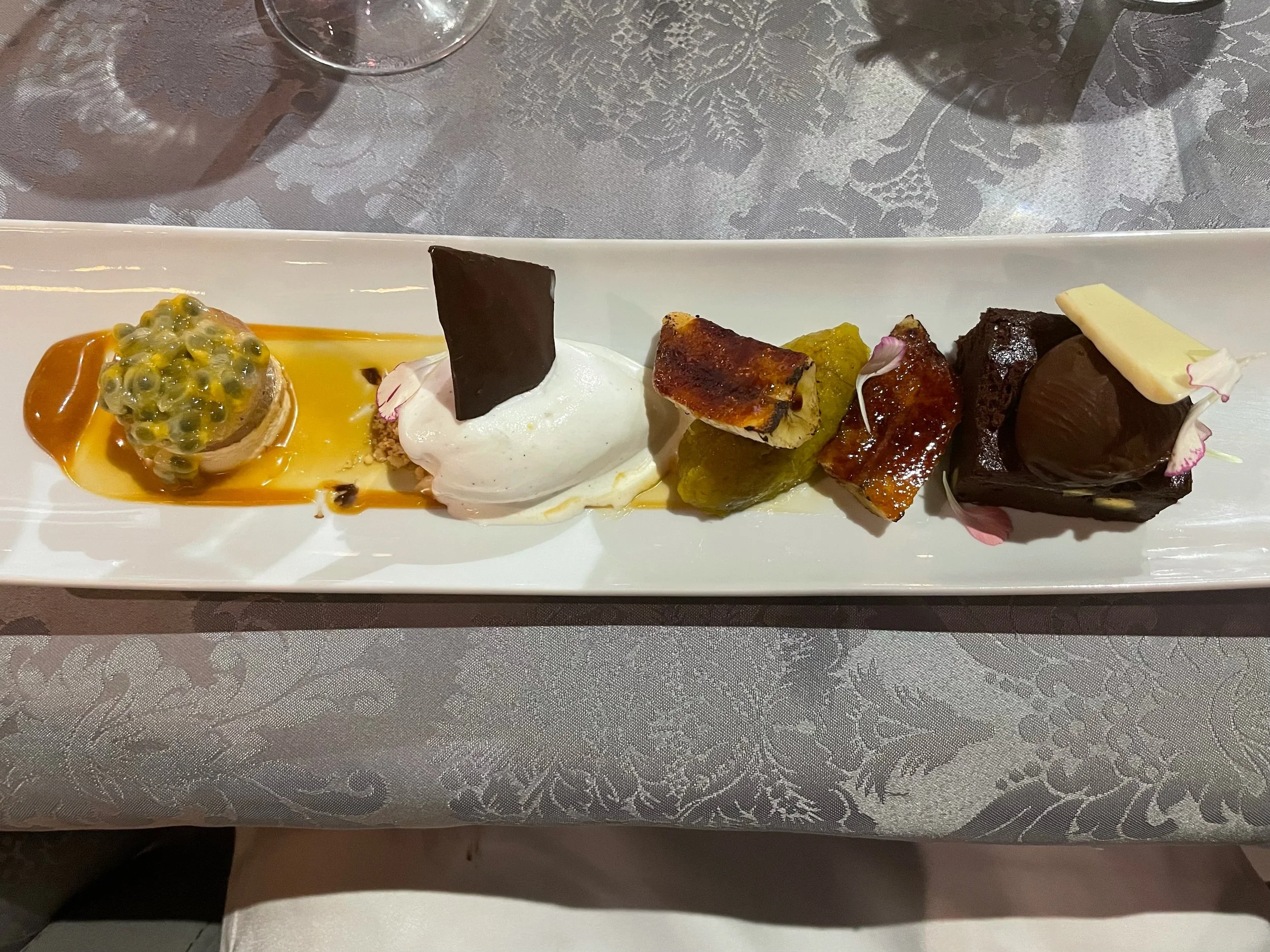 Dessert tasting plate featuring tropical fruit and chocolate at Armazém do Sal restaurant in Funchal.