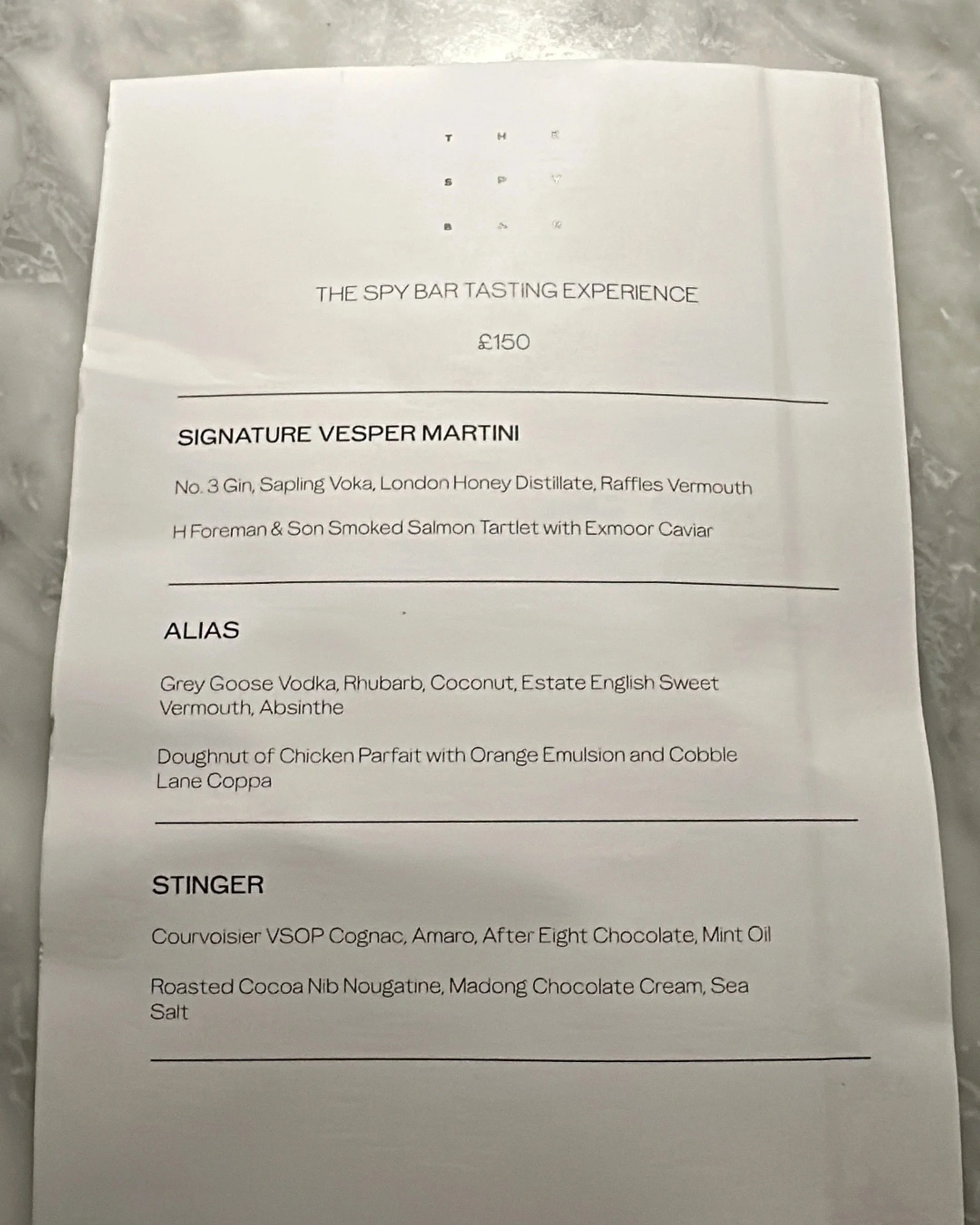 Spy Bar tasting experience menu at The OWO in London featuring cocktail and food pairings.