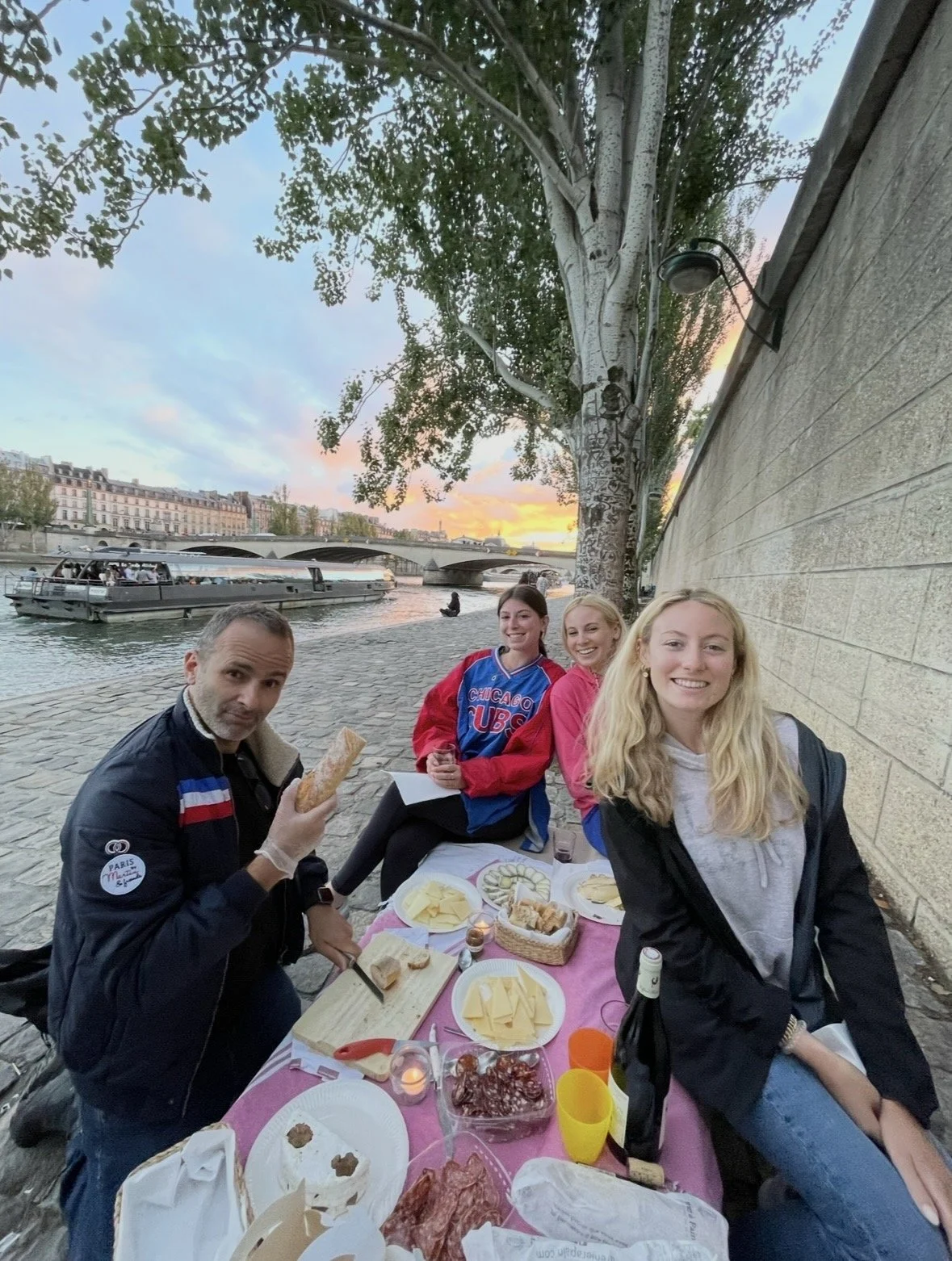 Evening picnic beside the Seine River in Paris