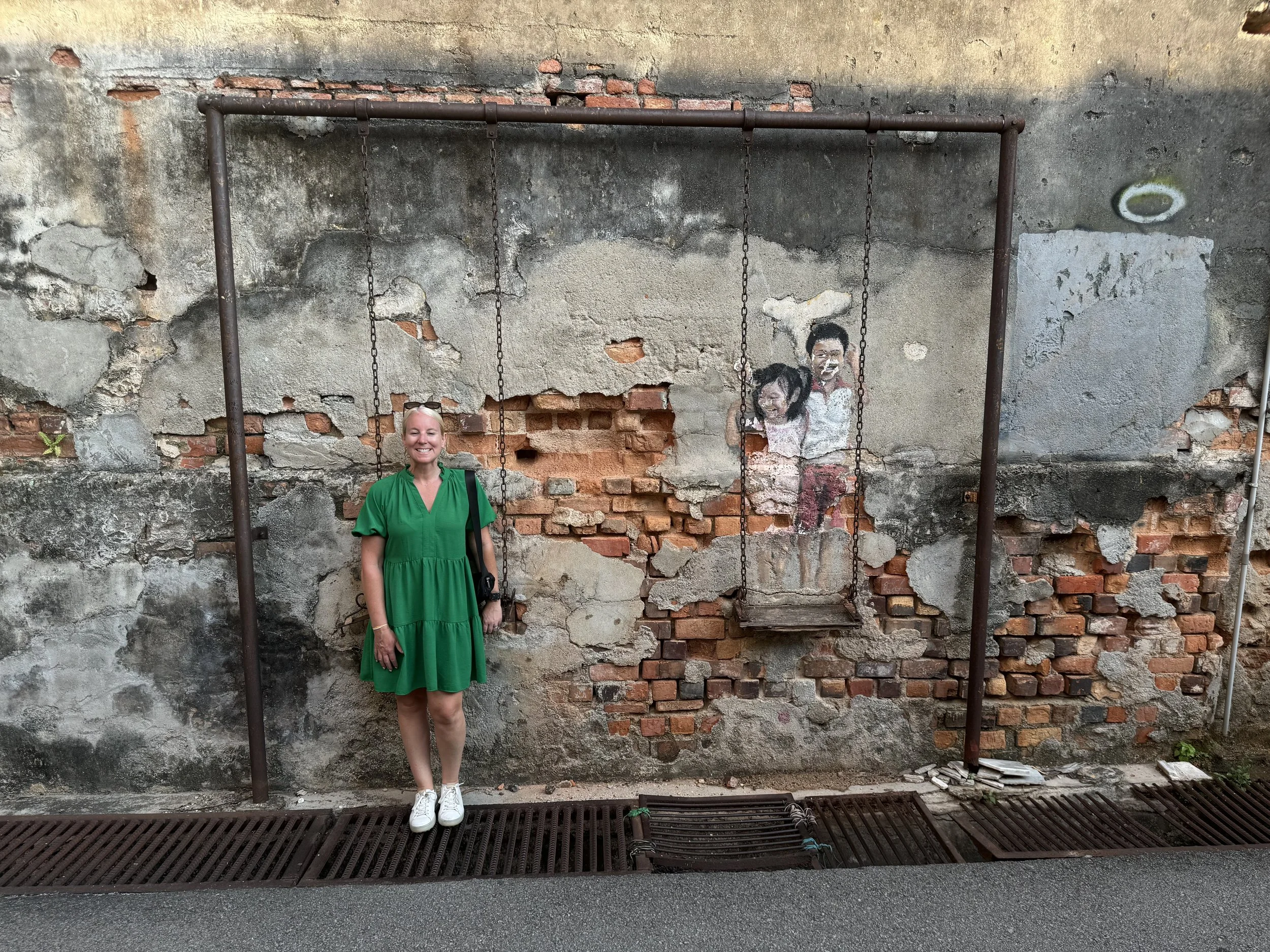 Girl on swing street art installation in George Town Penang