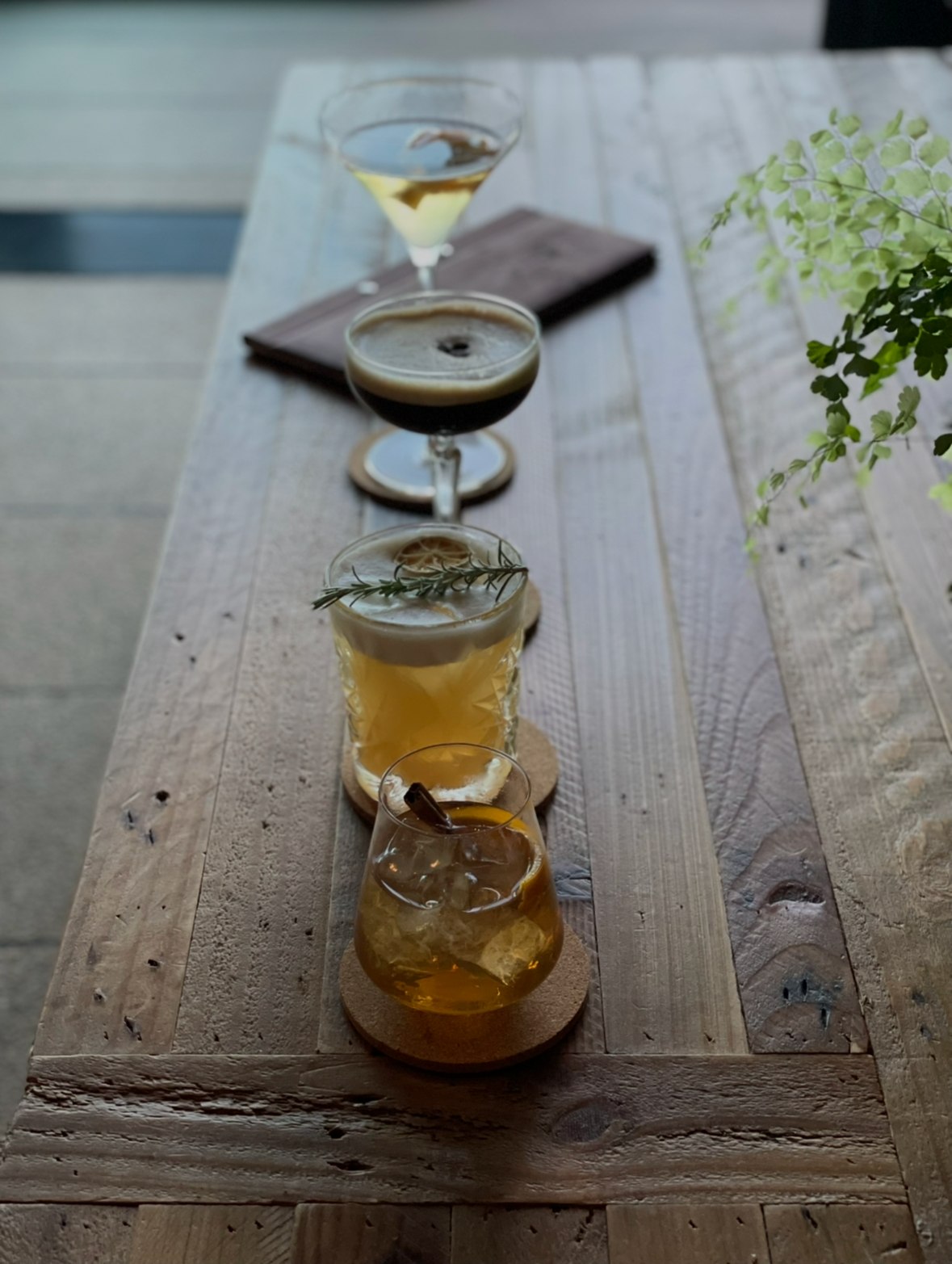 Craft cocktail tasting flight featuring seasonal drinks made with herbs grown on the estate