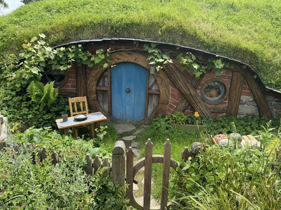 Blue Hobbit door surrounded by gardens at Hobbiton Movie Set in Matamata, New Zealand