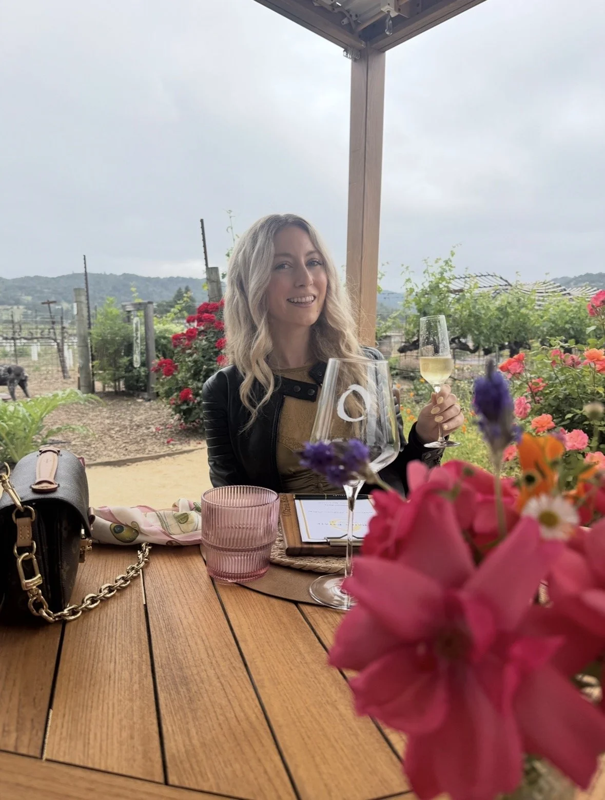 Outdoor wine tasting surrounded by flowers and vineyards at O’Brien Estate Winery in Napa Valley