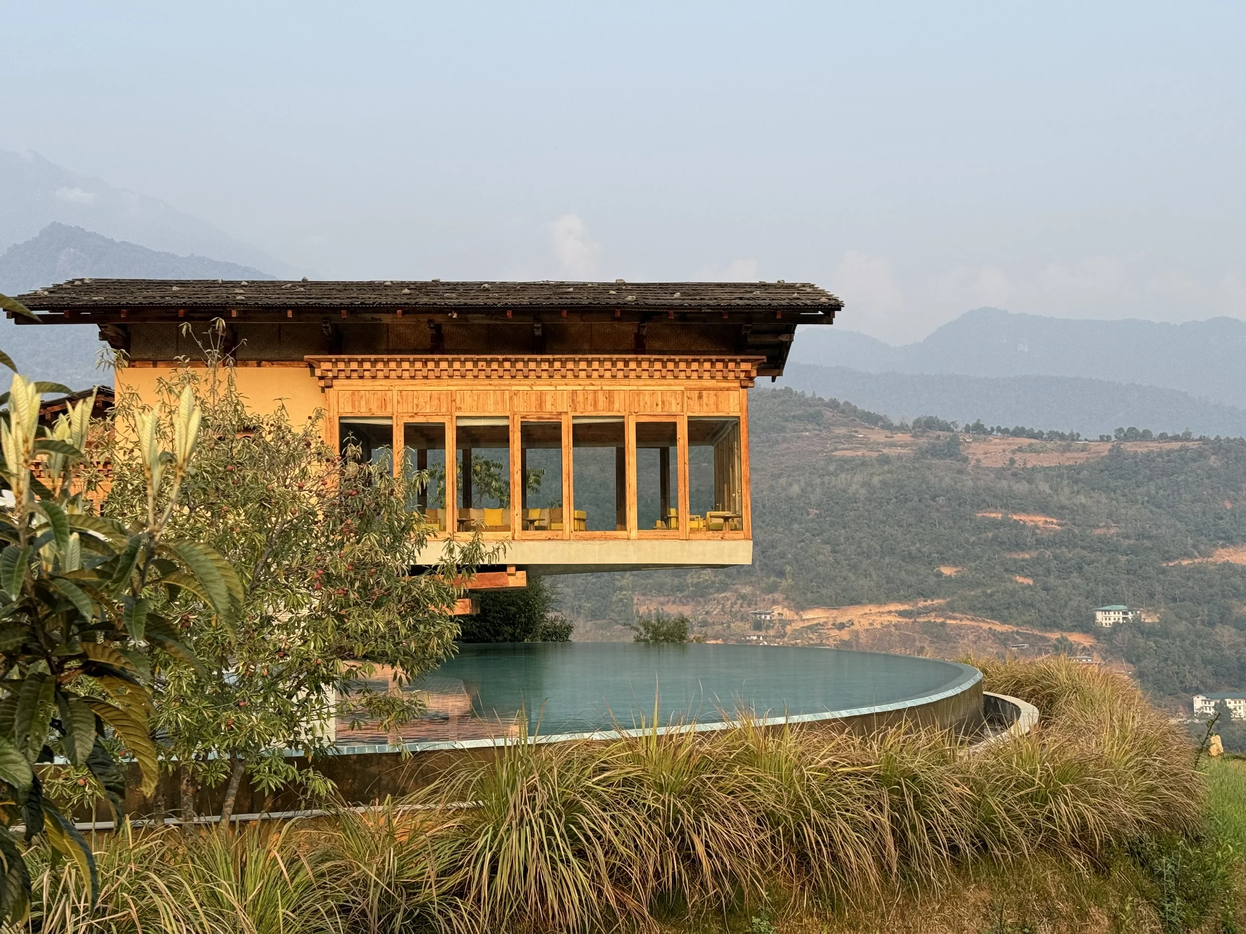 Six Senses Punakha lodge and infinity pool overlooking the Bhutanese countryside
