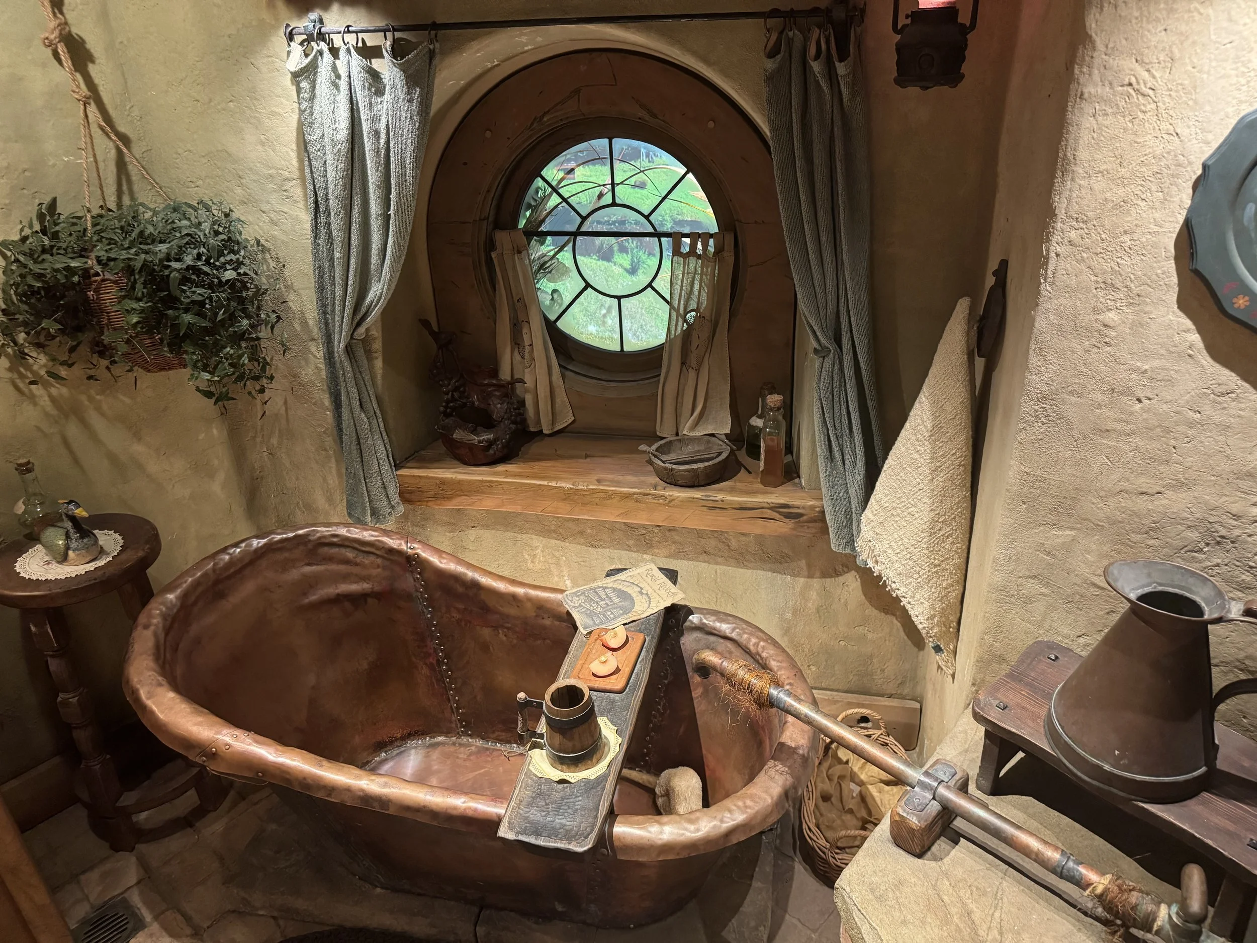Hobbit bathroom with round window inside the Hobbiton Movie Set interior tour