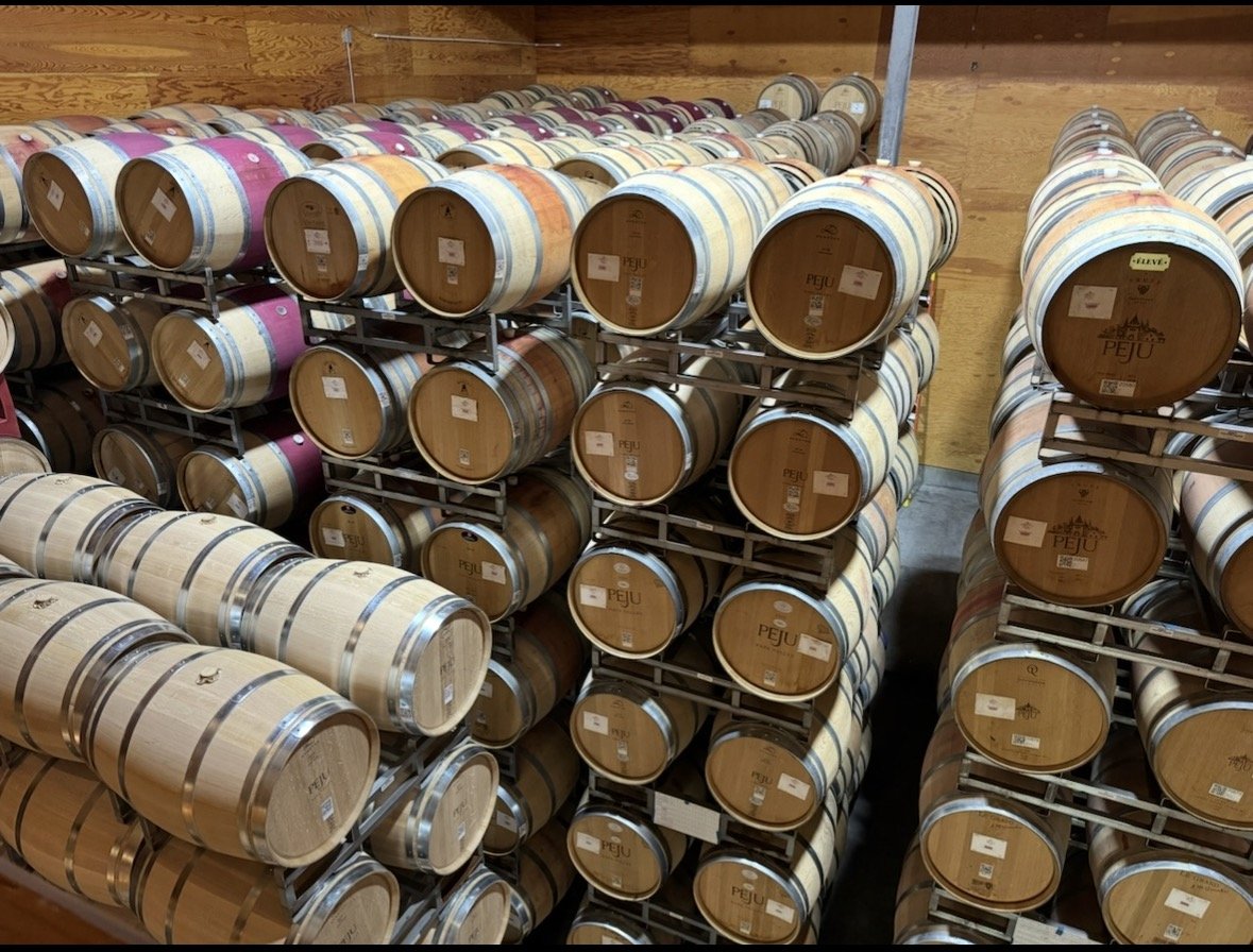 Wine barrels aging inside Peju Winery in Napa Valley