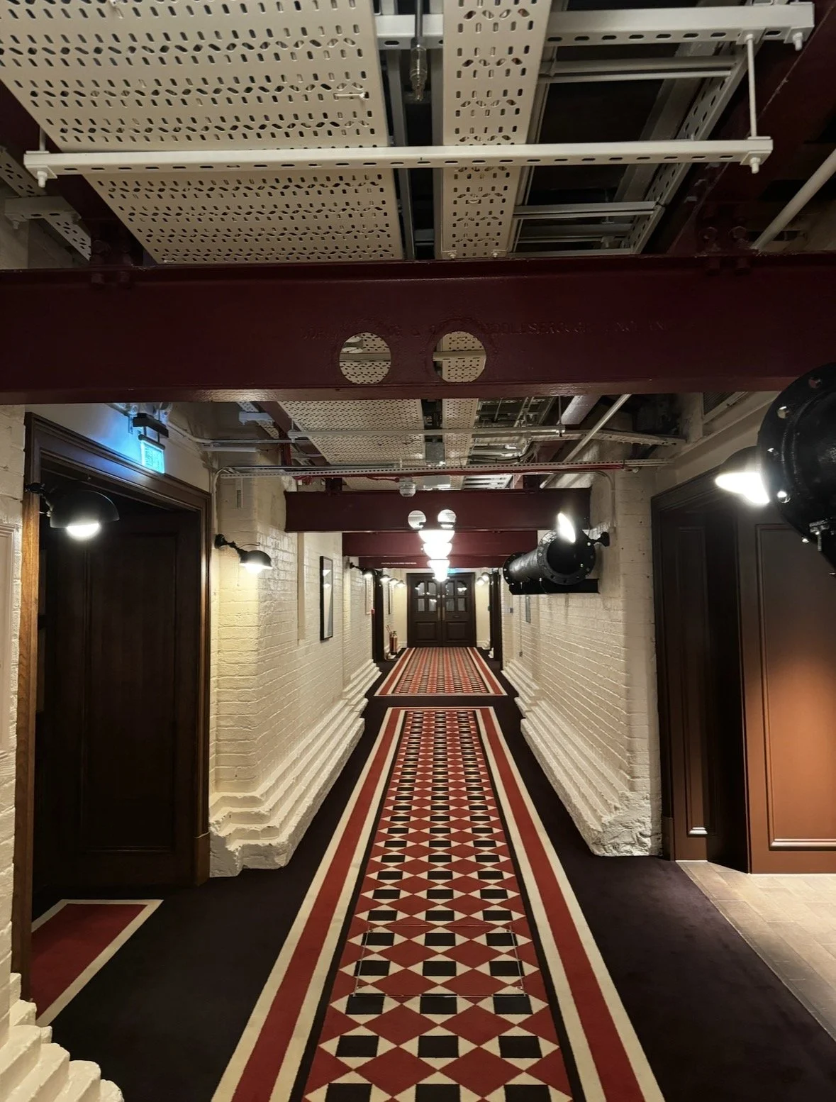 Historic corridor inside The OWO in London leading to Spy Bar.
