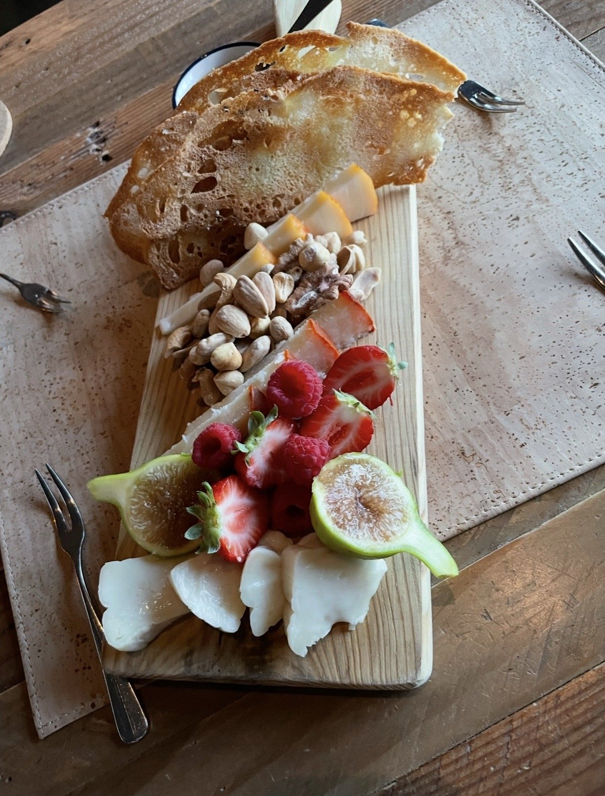 Portuguese cheese board with local cheeses, fresh fruit, nuts, and artisan bread in the Douro Valley.