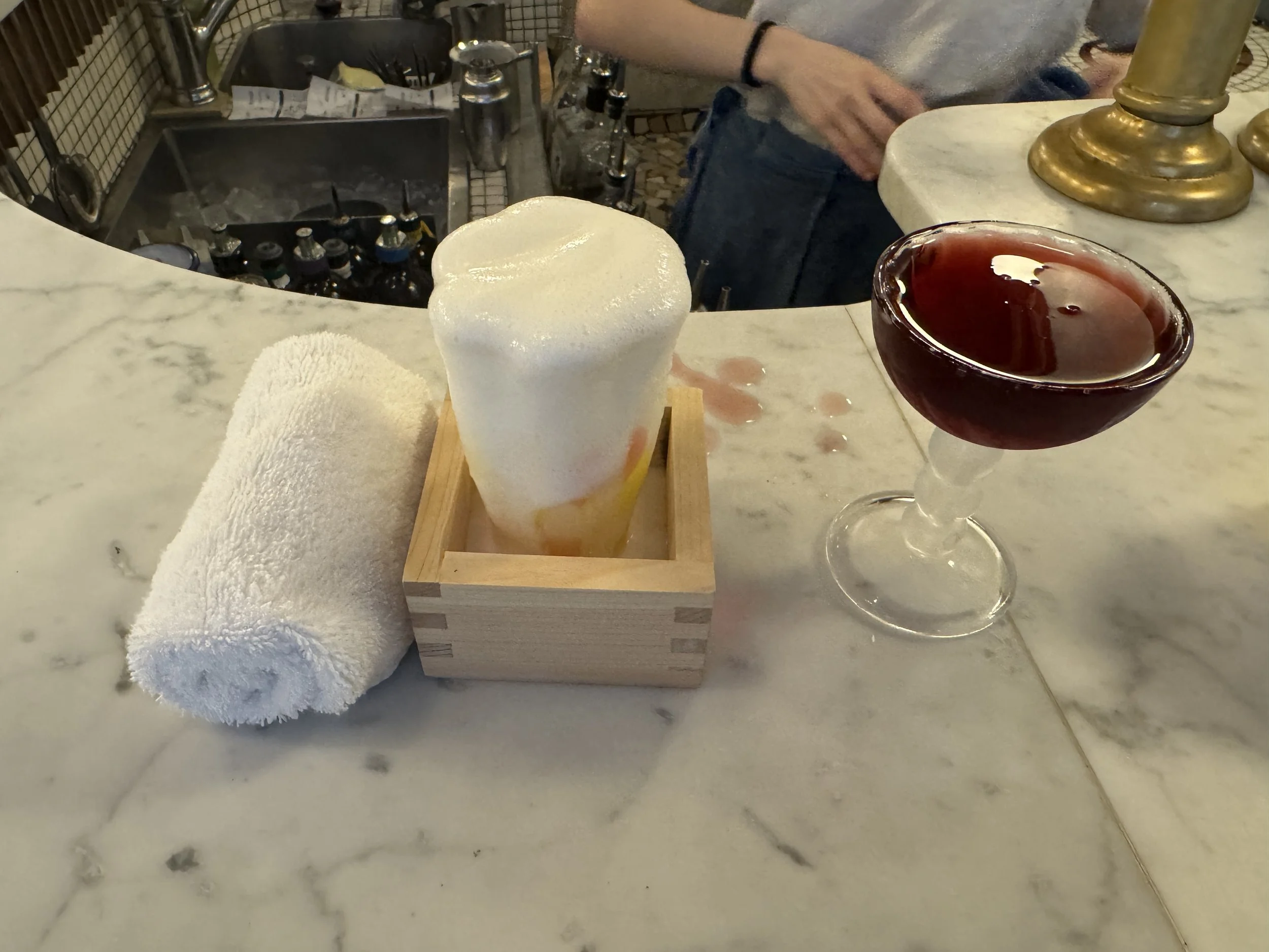 Creative cocktail with foam and coupe glass drink at Bar Nouveau Paris