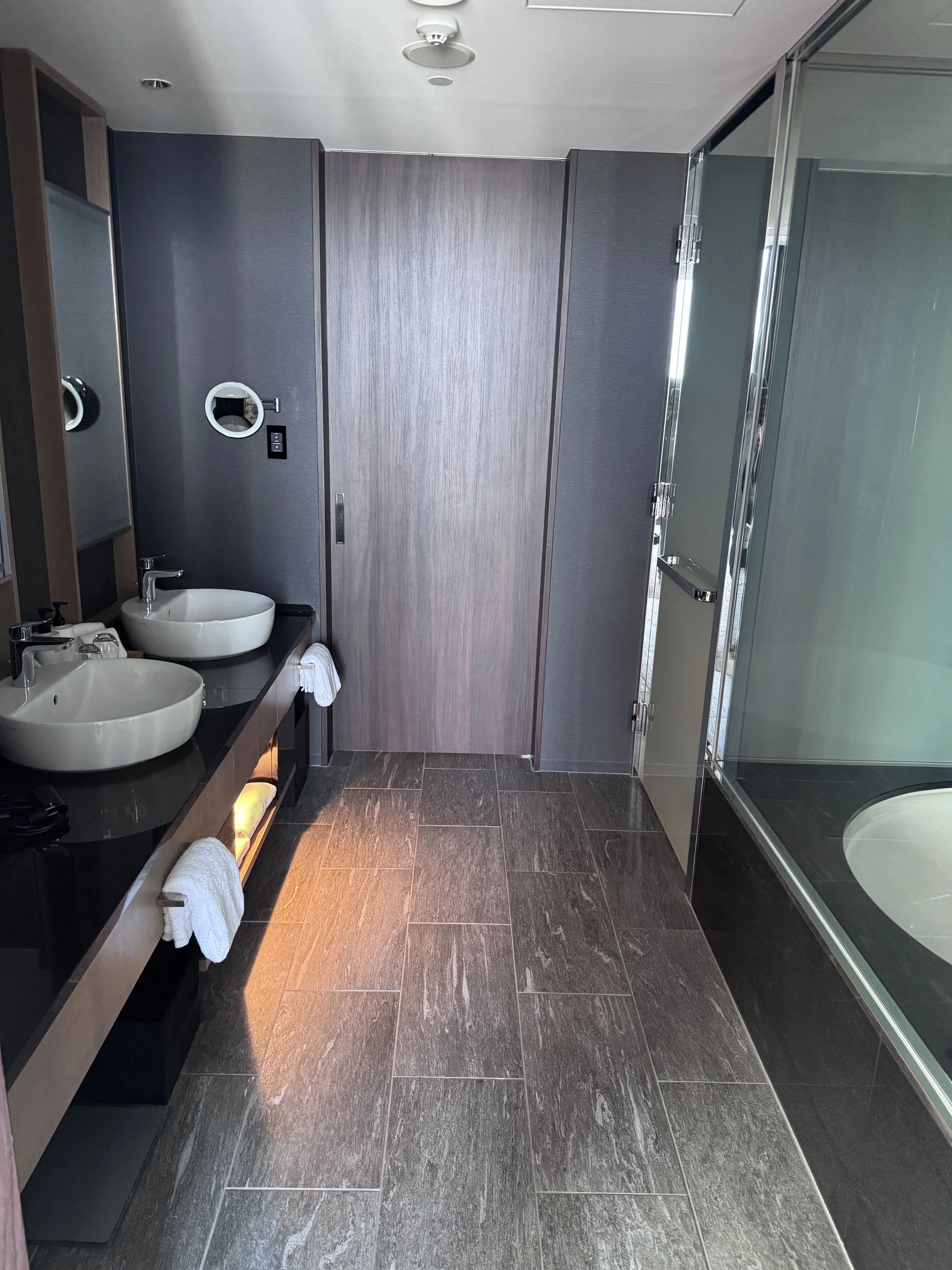 Luxury bathroom with double vanity and rain shower at Conrad Osaka