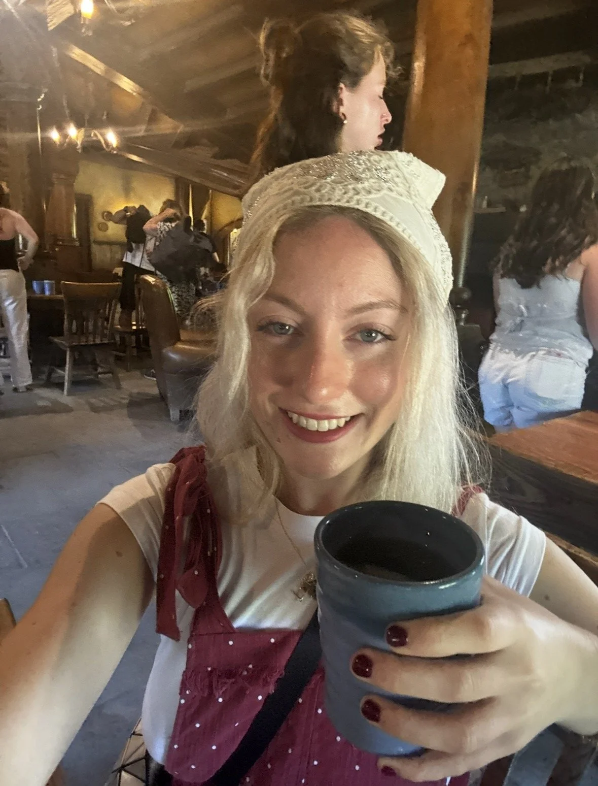 Visitor enjoying a complimentary drink inside the Green Dragon Inn at Hobbiton