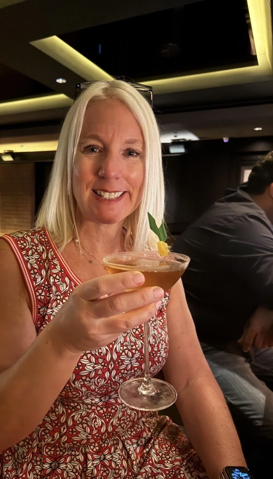 Guest enjoying a handcrafted cocktail at Manhattan Bar in Singapore.