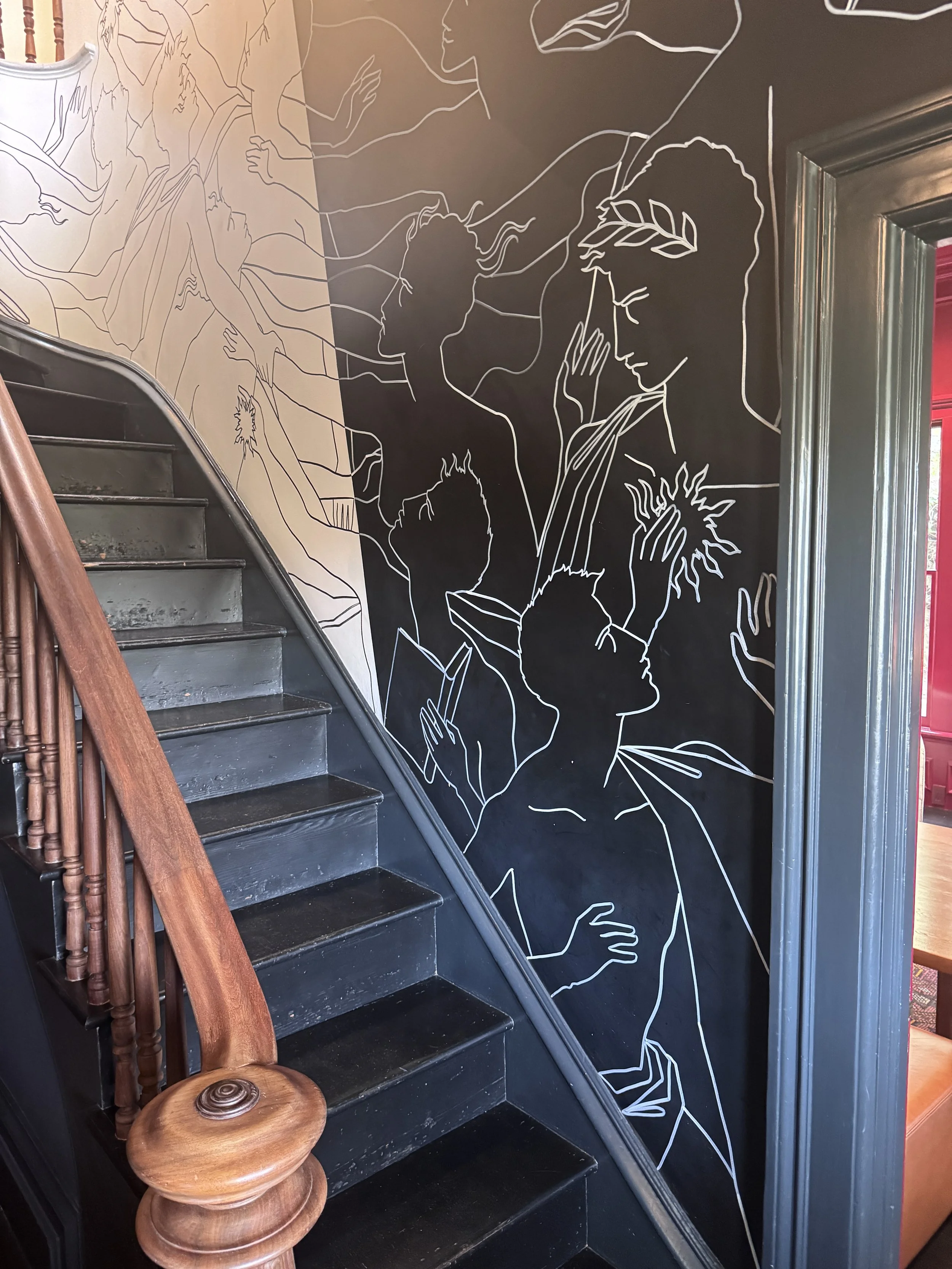 Artistic staircase and contemporary wall murals inside Faust Haus in Napa Valley