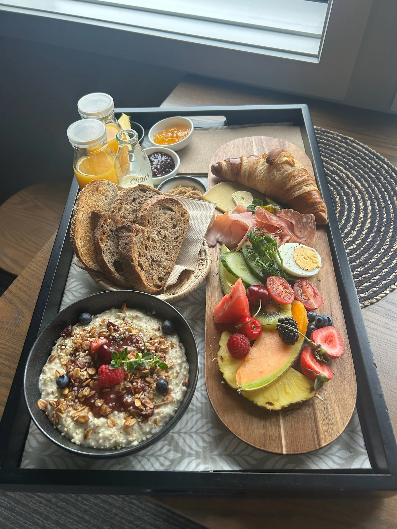 Gourmet breakfast with fresh fruit, croissant, artisan bread, yogurt, and local sparkling wine at a boutique hotel, 14 th lane urban hotel,  in Blenheim, Marlborough, New Zealand.