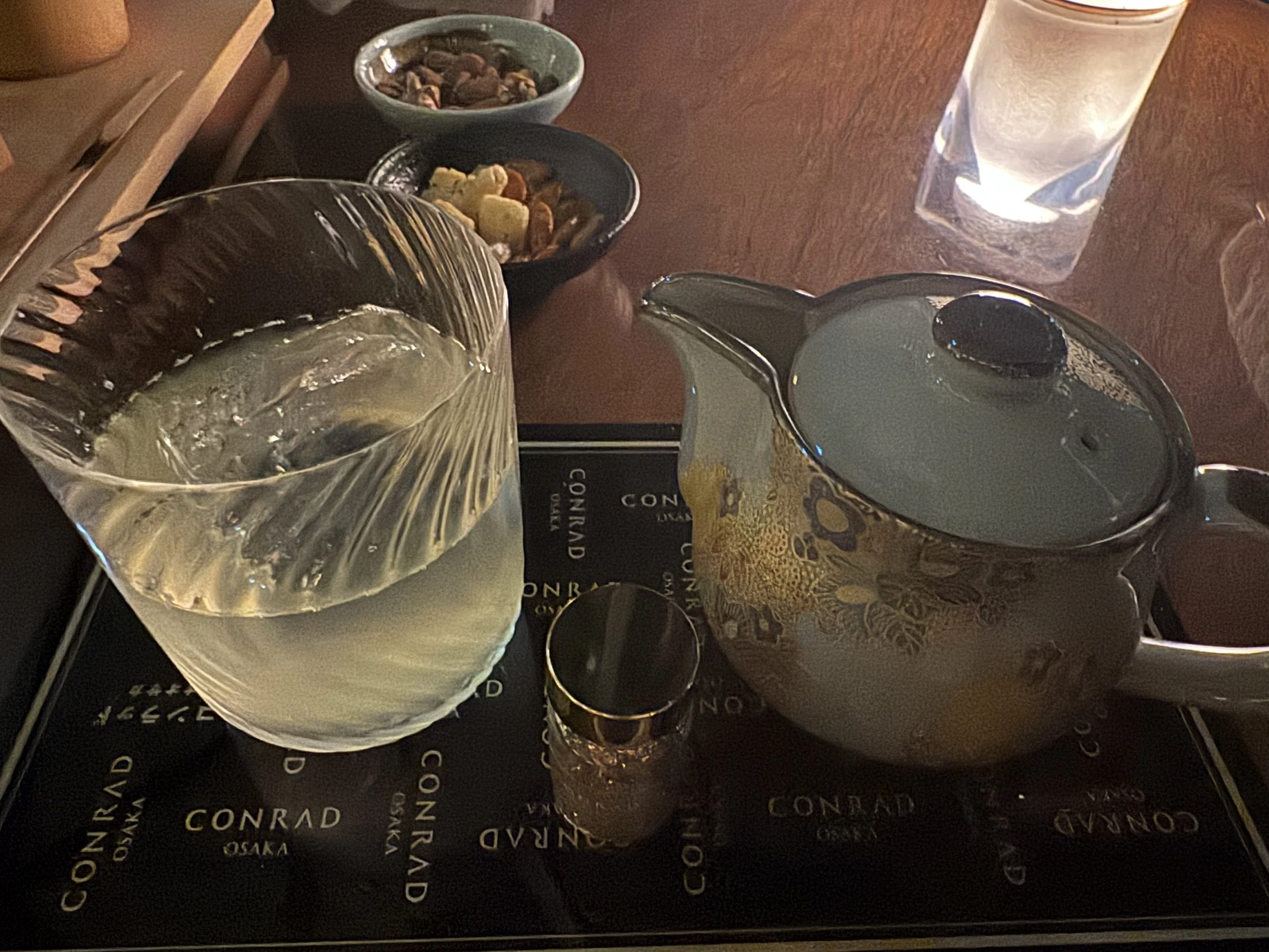 Signature cocktail service at the Conrad Osaka bar overlooking the skyline