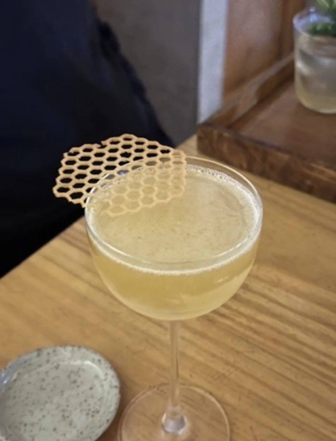Craft cocktail topped with an edible honeycomb garnish at Lady Bee, a modern cocktail bar in Lima, Peru.