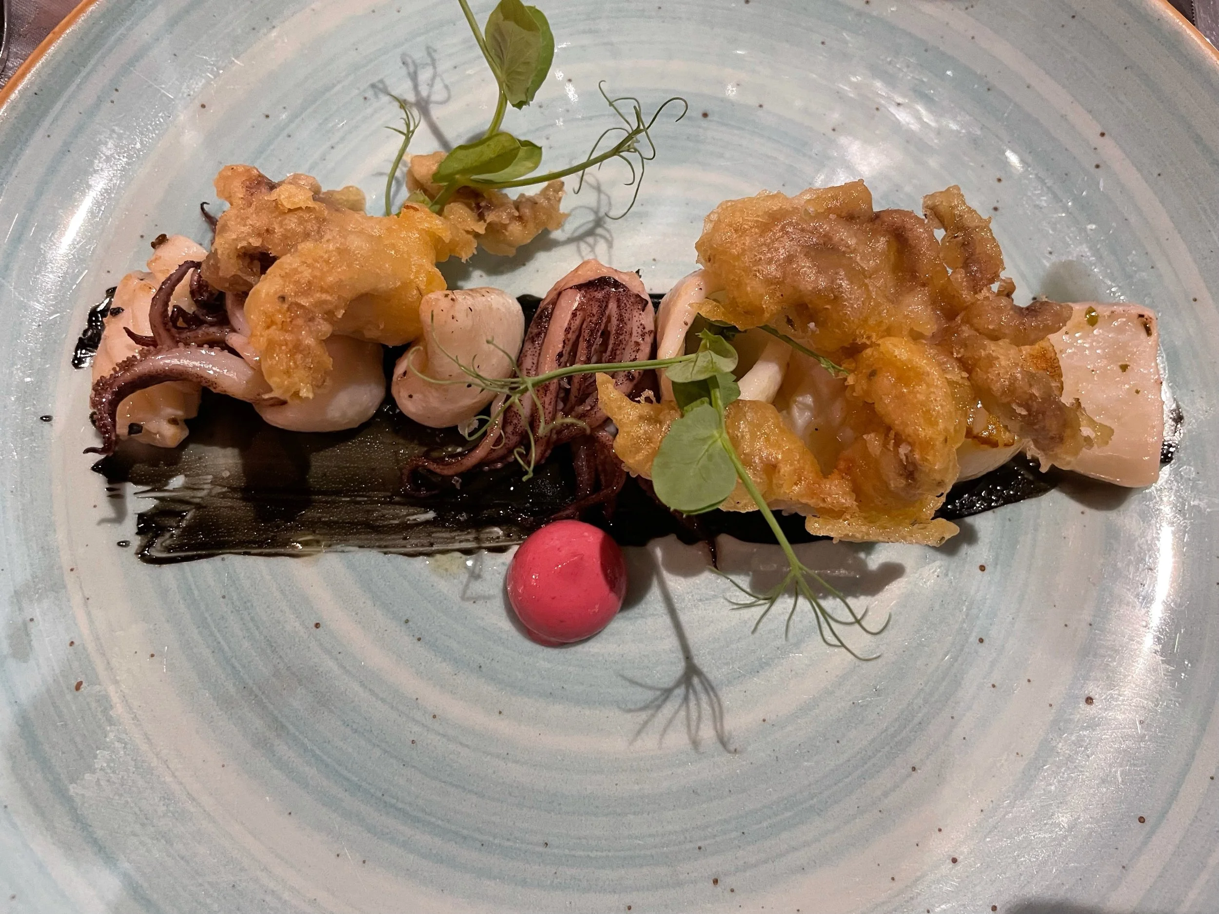 Creative squid and seafood appetizer served at Armazém do Sal restaurant in Funchal, Madeira.