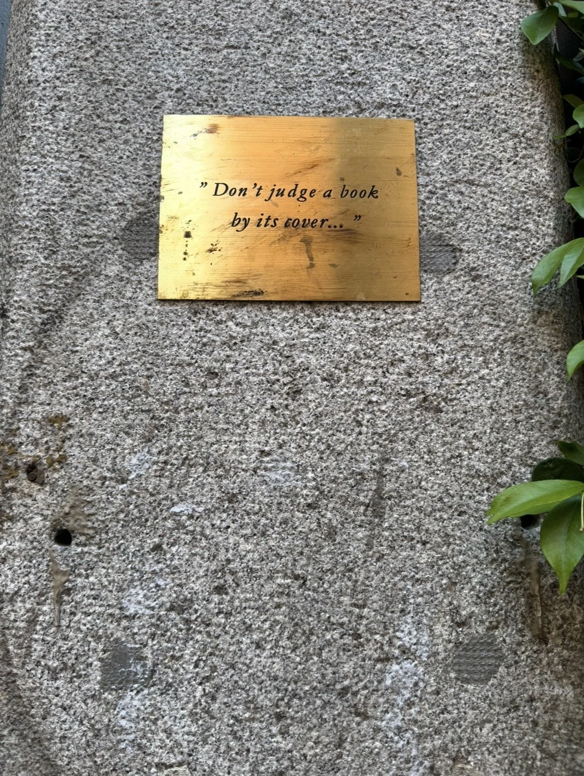 “Don’t judge a book by its cover” plaque outside Jack’s Library in Madrid