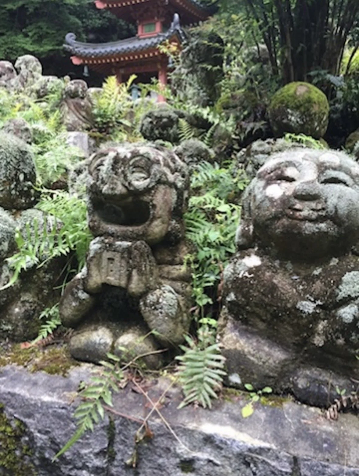 Moss-covered stone rakan statues at Otagi Nenbutsu-ji Temple in Kyoto, Japan