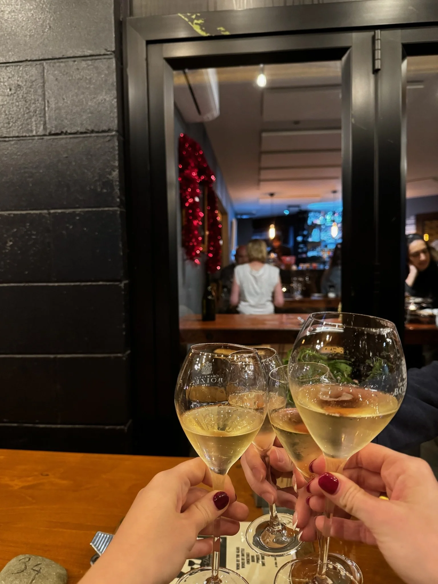 Toasting glasses of Marlborough Sauvignon Blanc at Scotch Wine Bar in Blenheim.