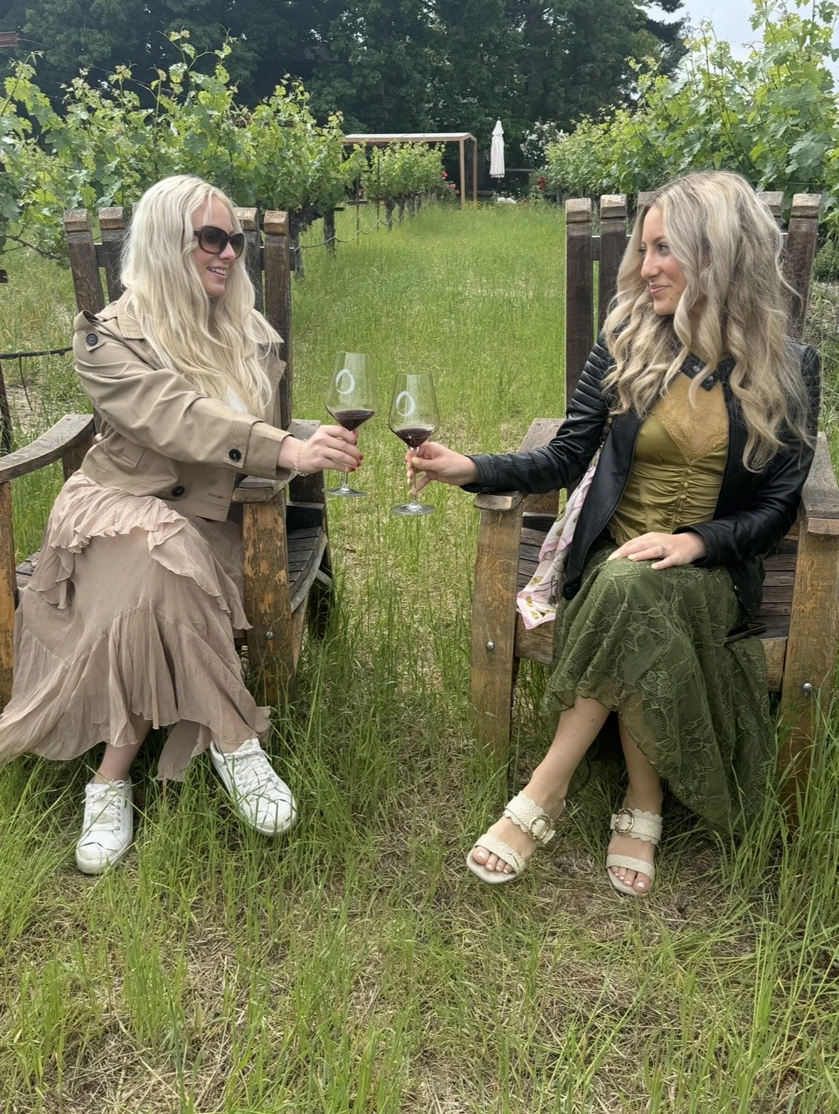 Guests enjoying O’Brien Estate red wine while seated between vineyard rows in Napa Valley