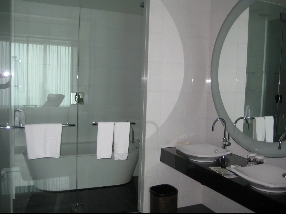 Conrad Tokyo bathroom with soaking tub and glass enclosed shower