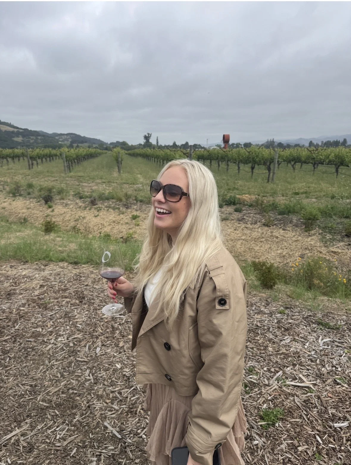 Walking through the vineyards with a glass of red wine at O’Brien Estate Winery in Napa Valley