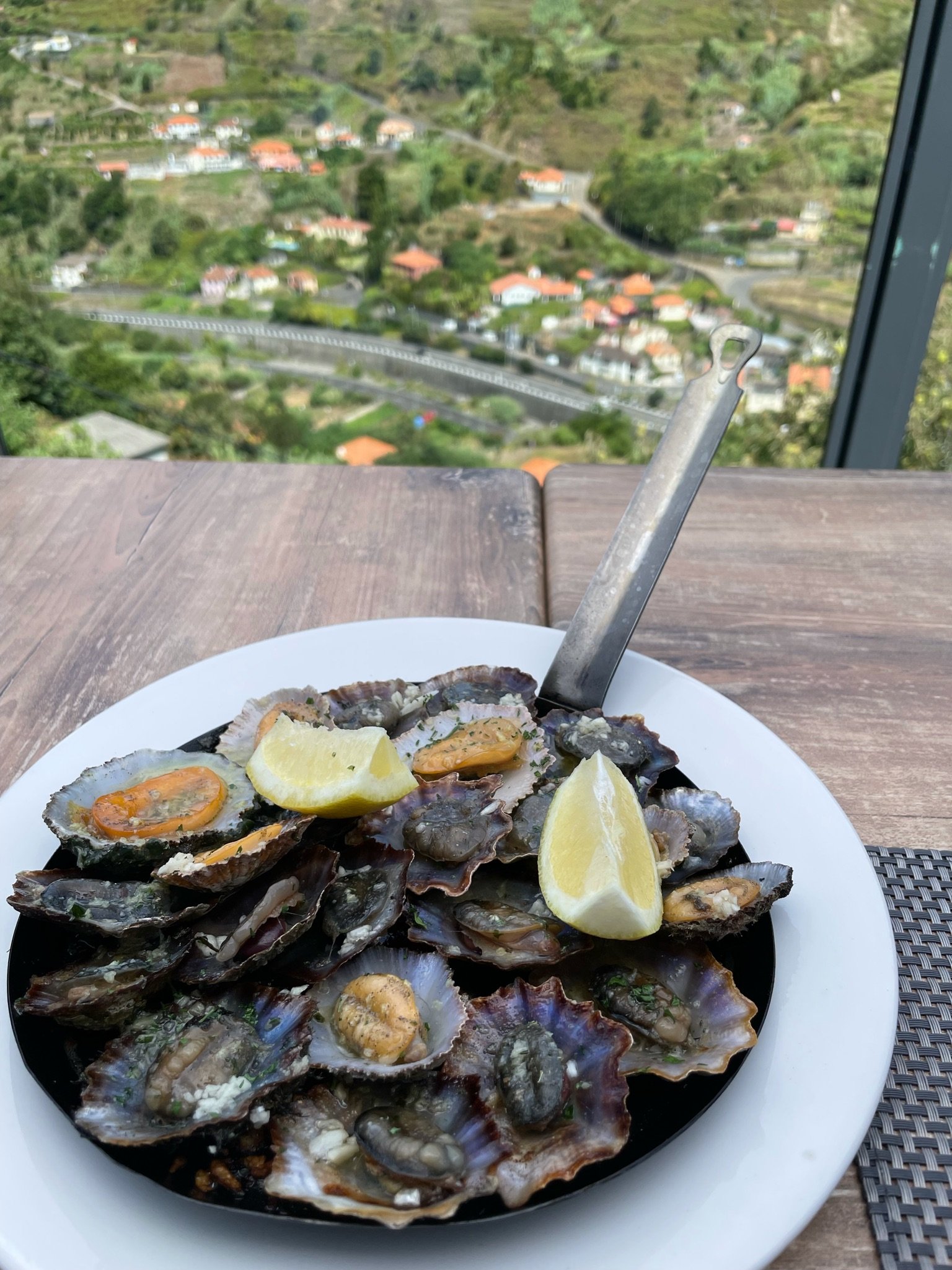 Fresh Madeiran limpets (lapas) served at Larador Restaurant overlooking the mountains of Madeira.