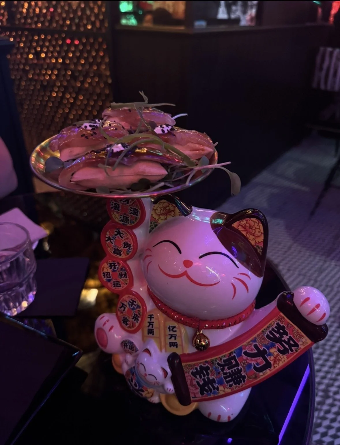 Playful lucky cat presentation at Salmon Guru cocktail bar in Madrid