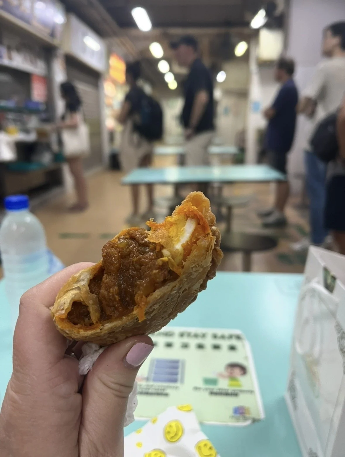 Freshly baked Singapore curry puff with flaky pastry and savory curried filling