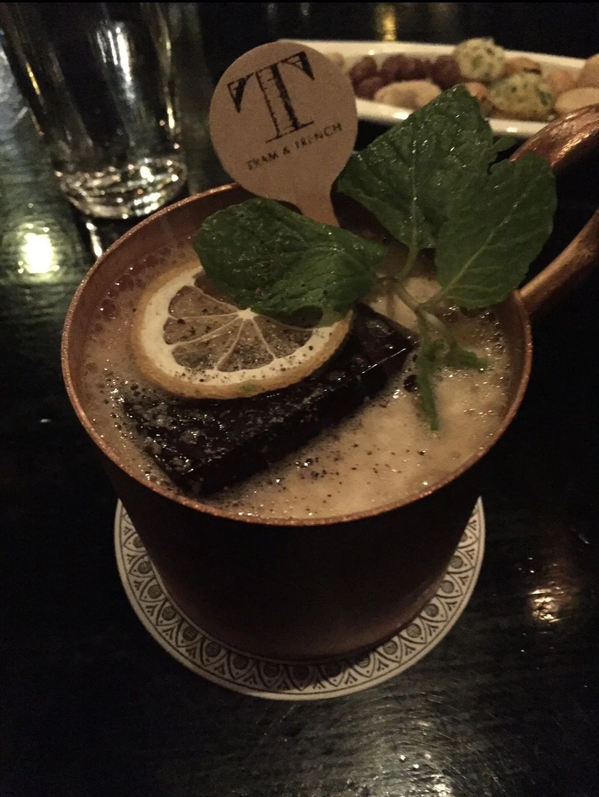 Signature cocktail at Bar Trench Tokyo served in a copper mug with mint and lemon garnish