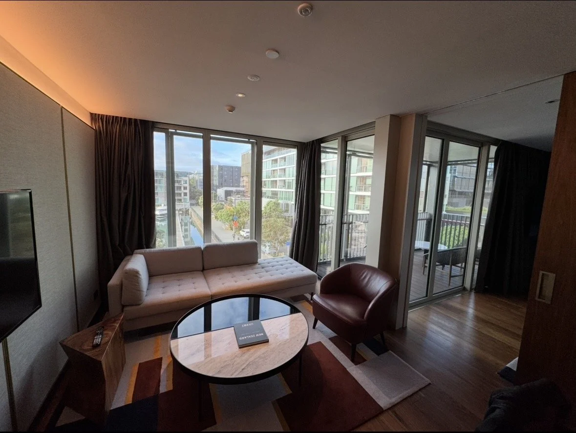 Spacious suite living room with floor-to-ceiling windows at Park Hyatt Auckland