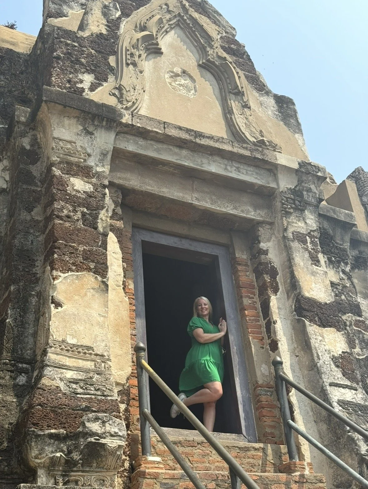 Traveler standing in the doorway of Wat Ratcha Burana temple in Ayutthaya Thailand