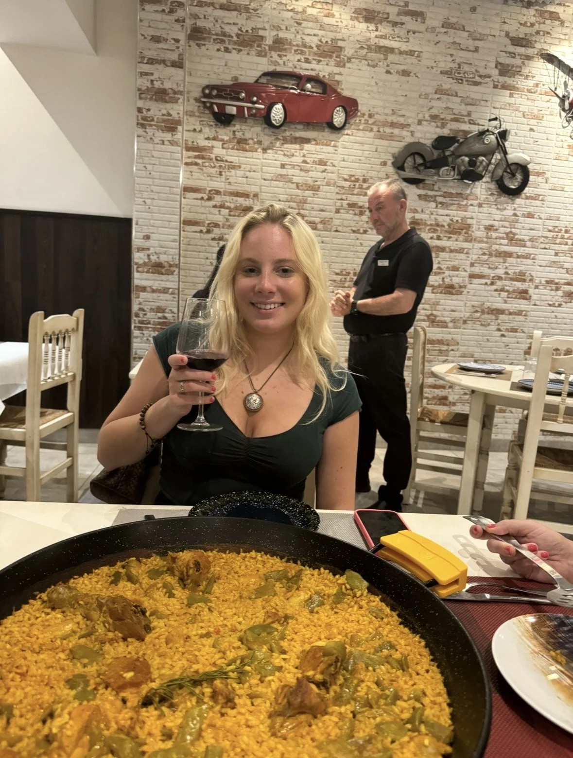 Traditional Valencian paella and wine at restaurant in Valencia Spain