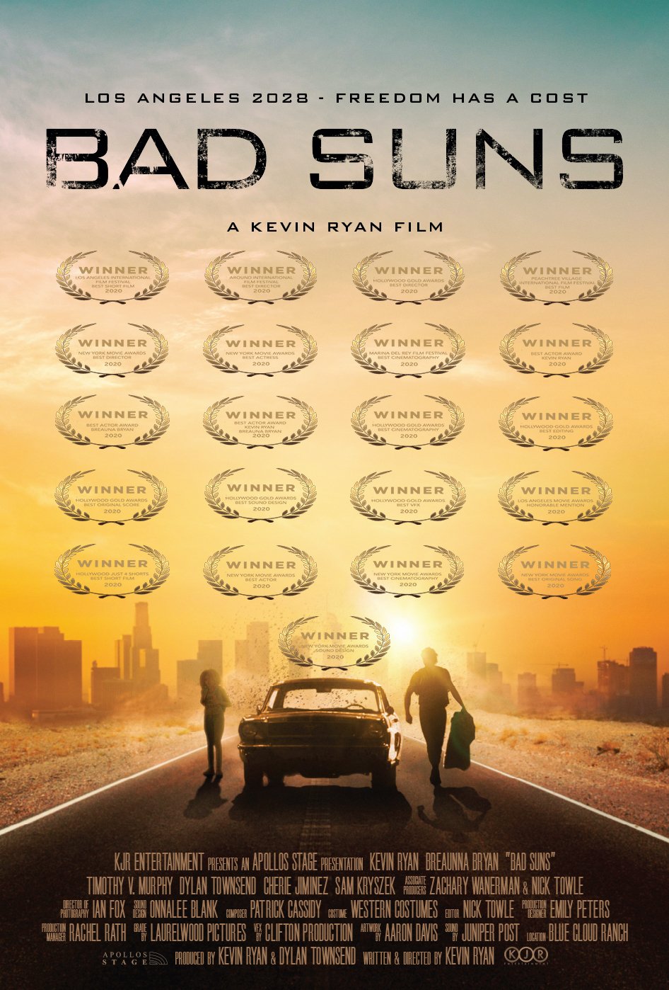 Movie poster for 'Bad Suns' featuring a city skyline at sunset, with an old car and two people walking away, surrounded by multiple award laurels from 2020. Kevin Ryan, Dylan Townsend.