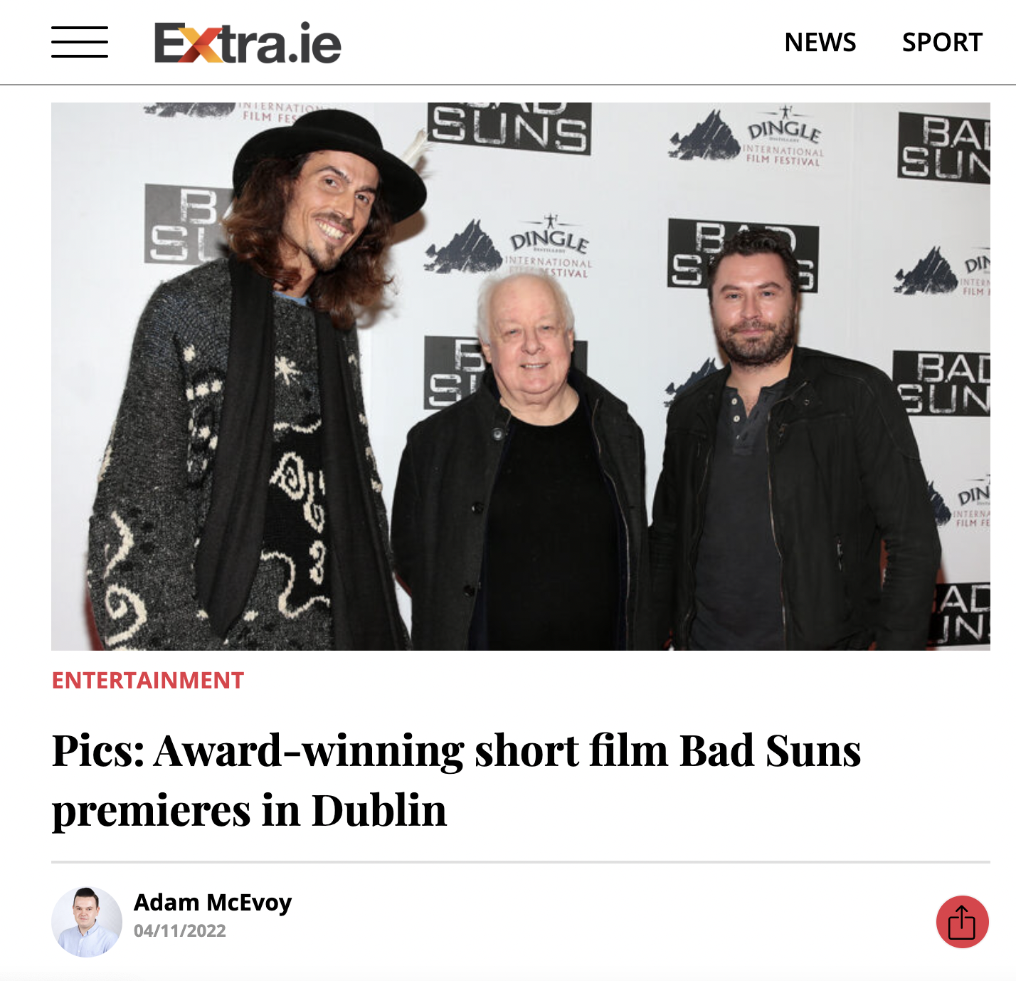 Dylan Townsend, Jim Sheridan and Kevin Ryan standing together in front of a step and repeat banner for the Dingle International Film Festival. 