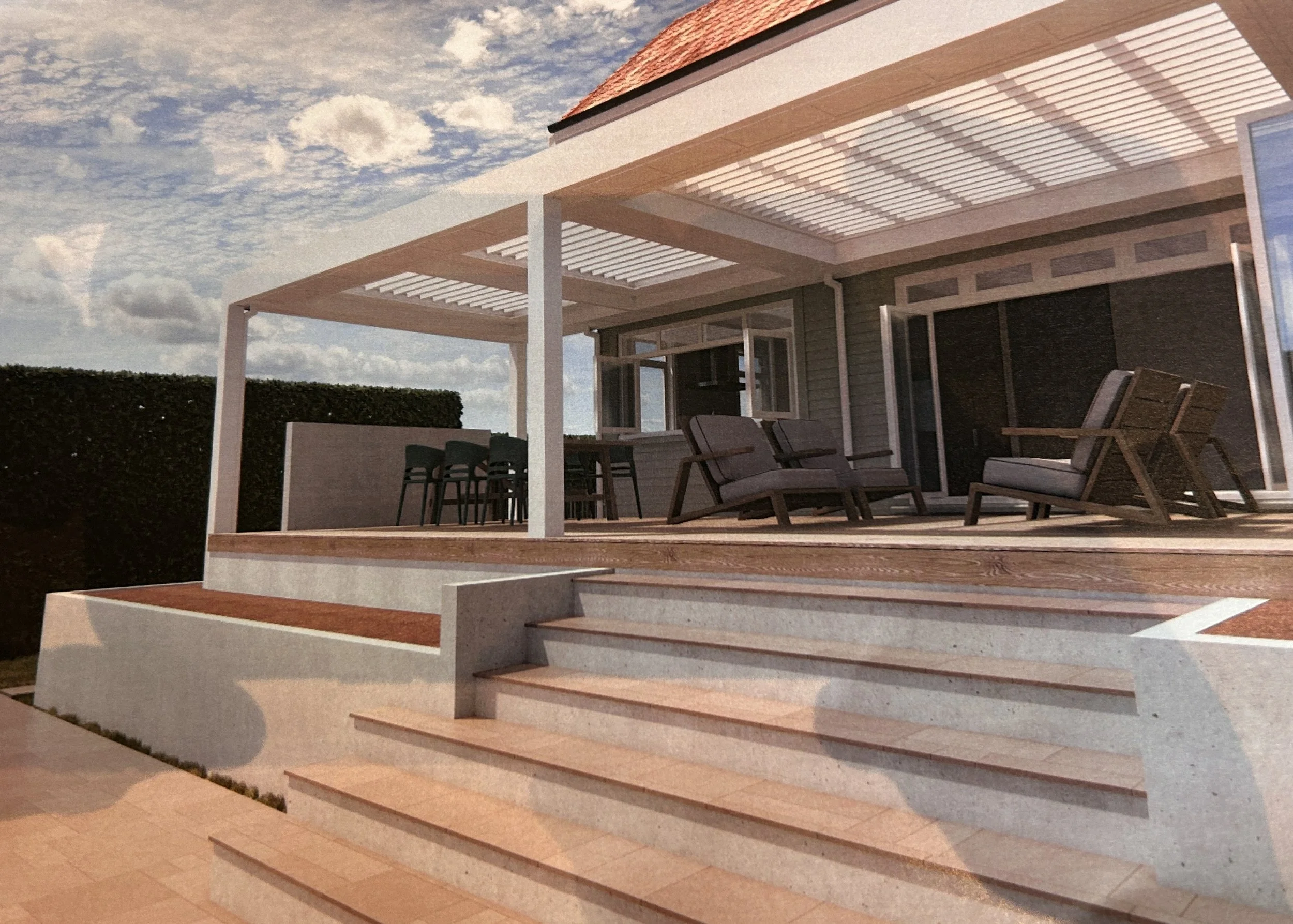 Exterior view of a modern house with a wooden deck, outdoor furniture, and a pergola, under a partly cloudy sky.
