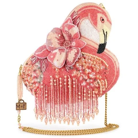Pink flamingo-shaped handbag with a large pink flower embellishment and gold chain strap.