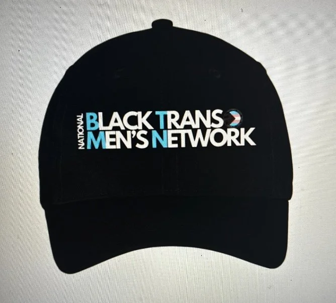 Black baseball cap with logo for 'National Black Trans Men's Network'.