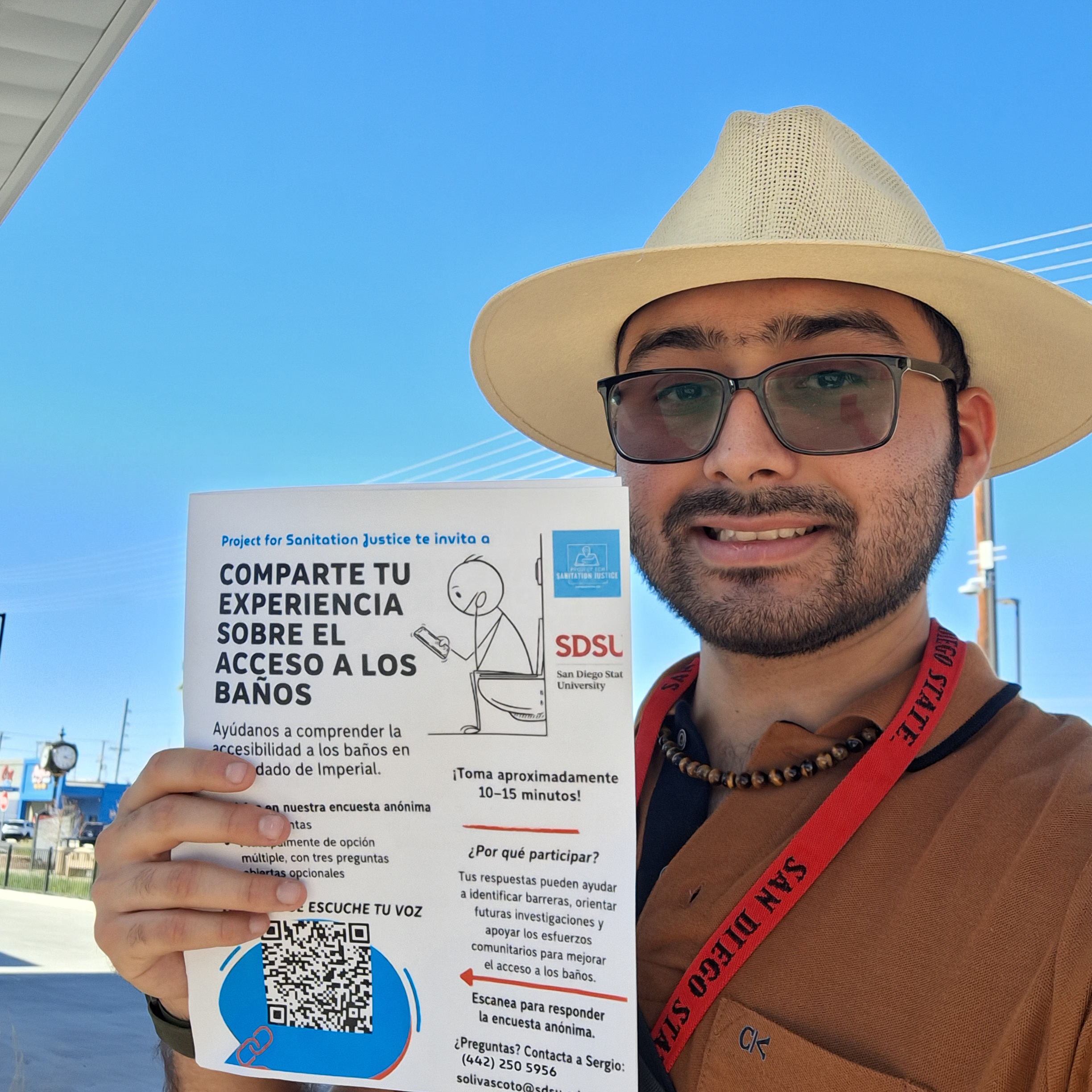 Sergio Olivas Coto distributing a flyer for his survey to understand Imperial County residents' experiences of public restroom access.